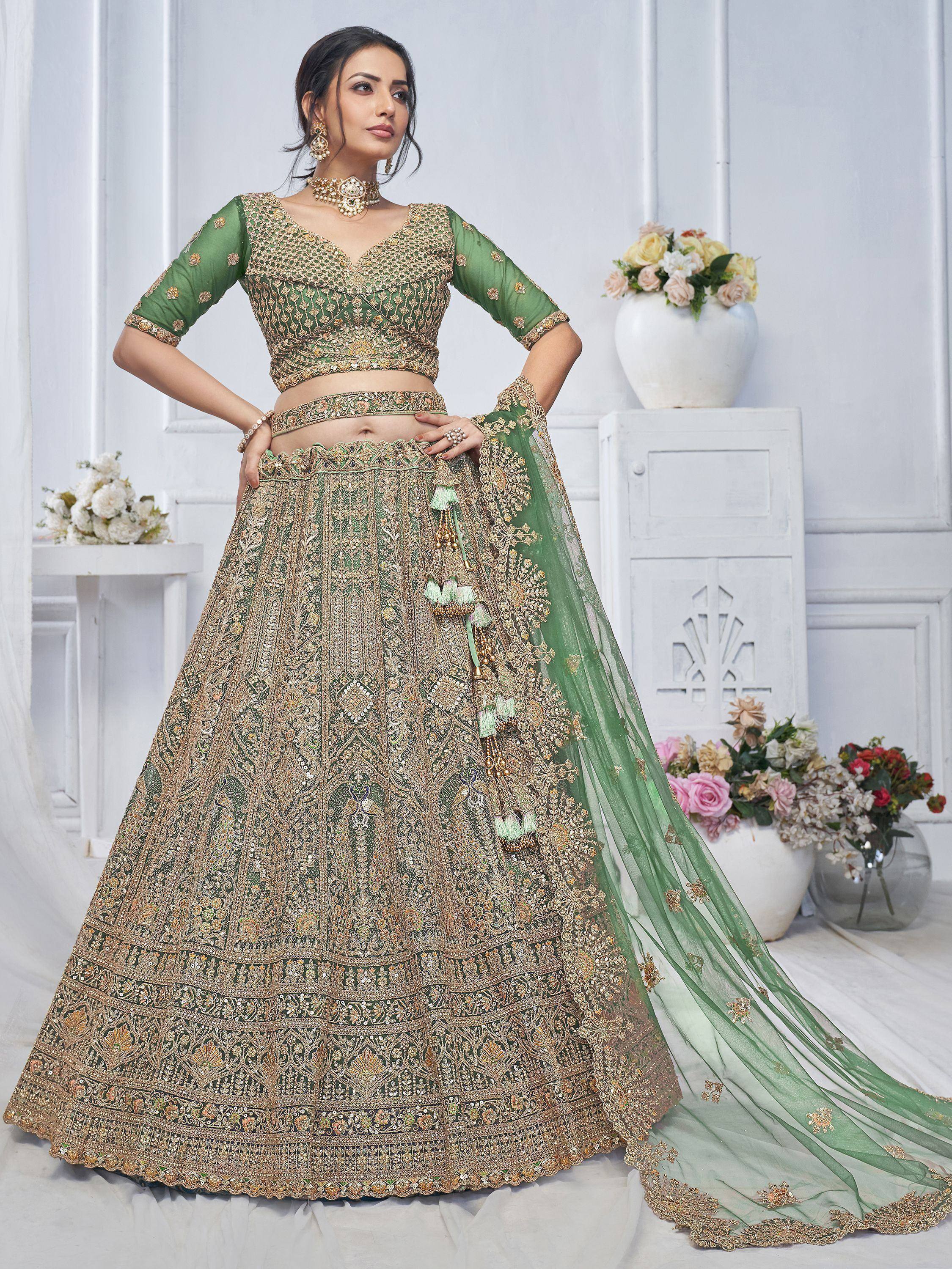 Emerald green designer lehenga choli with heavy gold embroidery and tassels, perfect for weddings