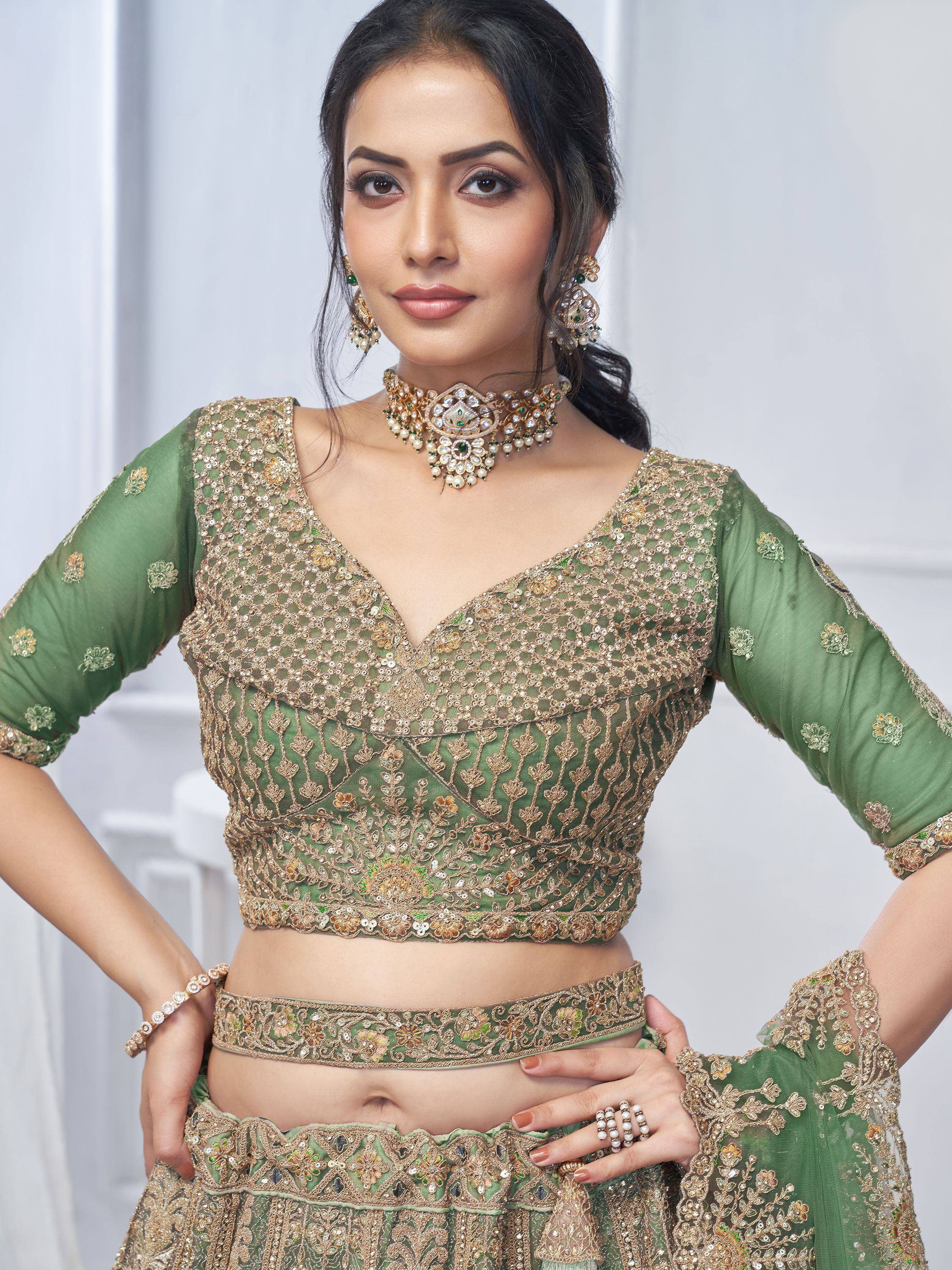 Green designer lehenga choli with gold embroidery and matching jewelry for Indian ethnic wear