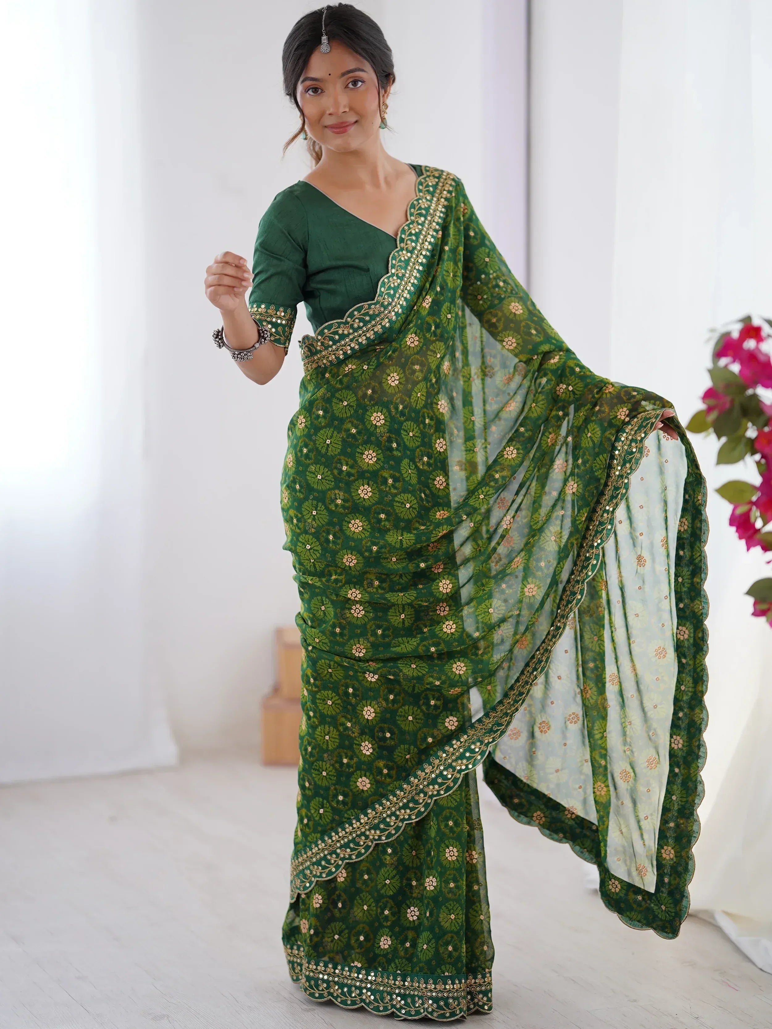 Green floral print saree with gold embroidery and scalloped border, paired with matching blouse for ethnic wear.