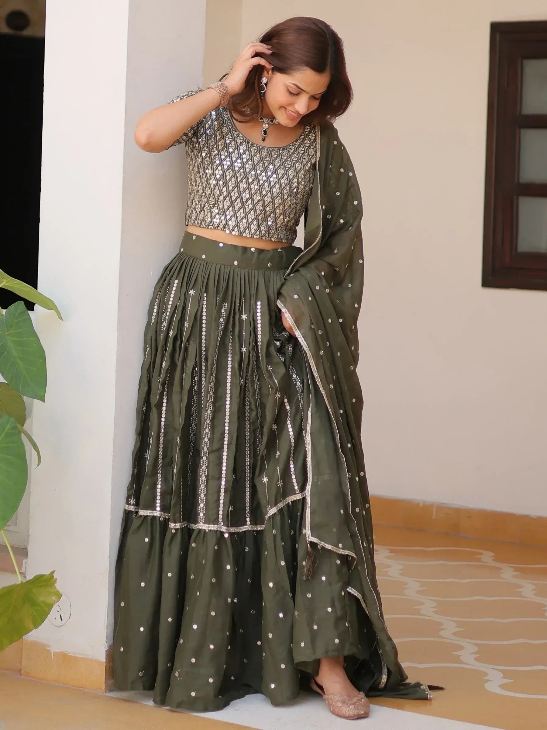 Olive green lehenga choli with silver mirror work and sequin blouse, perfect for Indian ethnic wear events.