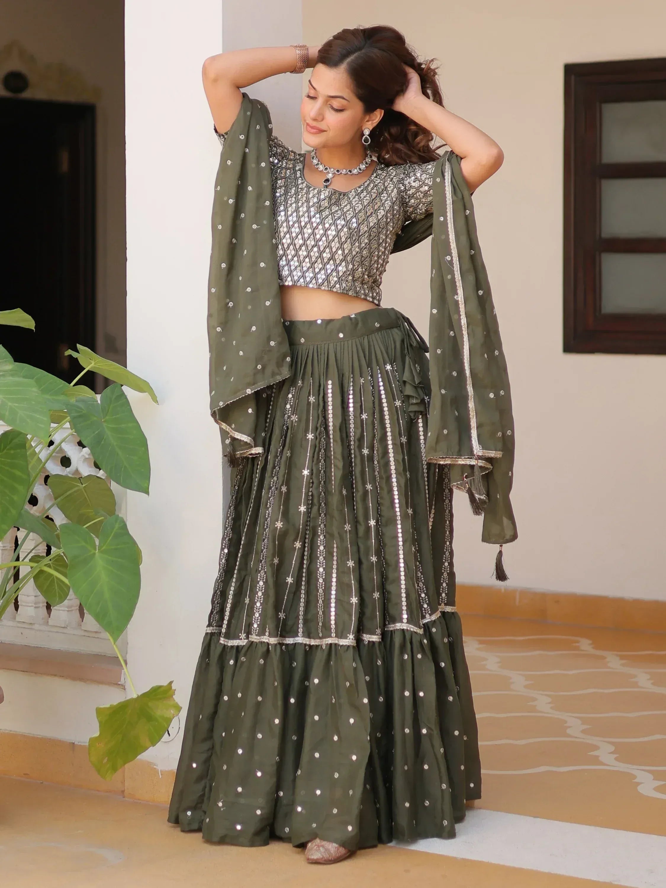 Olive green lehenga choli with mirror work and silver embroidery, perfect for Indian ethnic wear occasions.