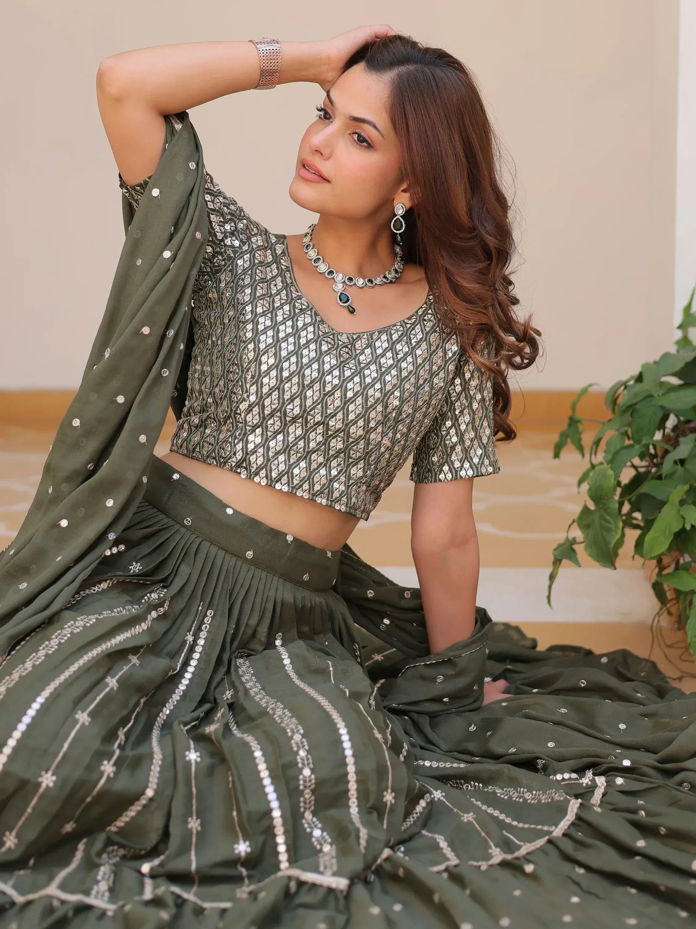 Olive green designer lehenga choli with sequin embroidery, perfect for Indian ethnic wear occasions.