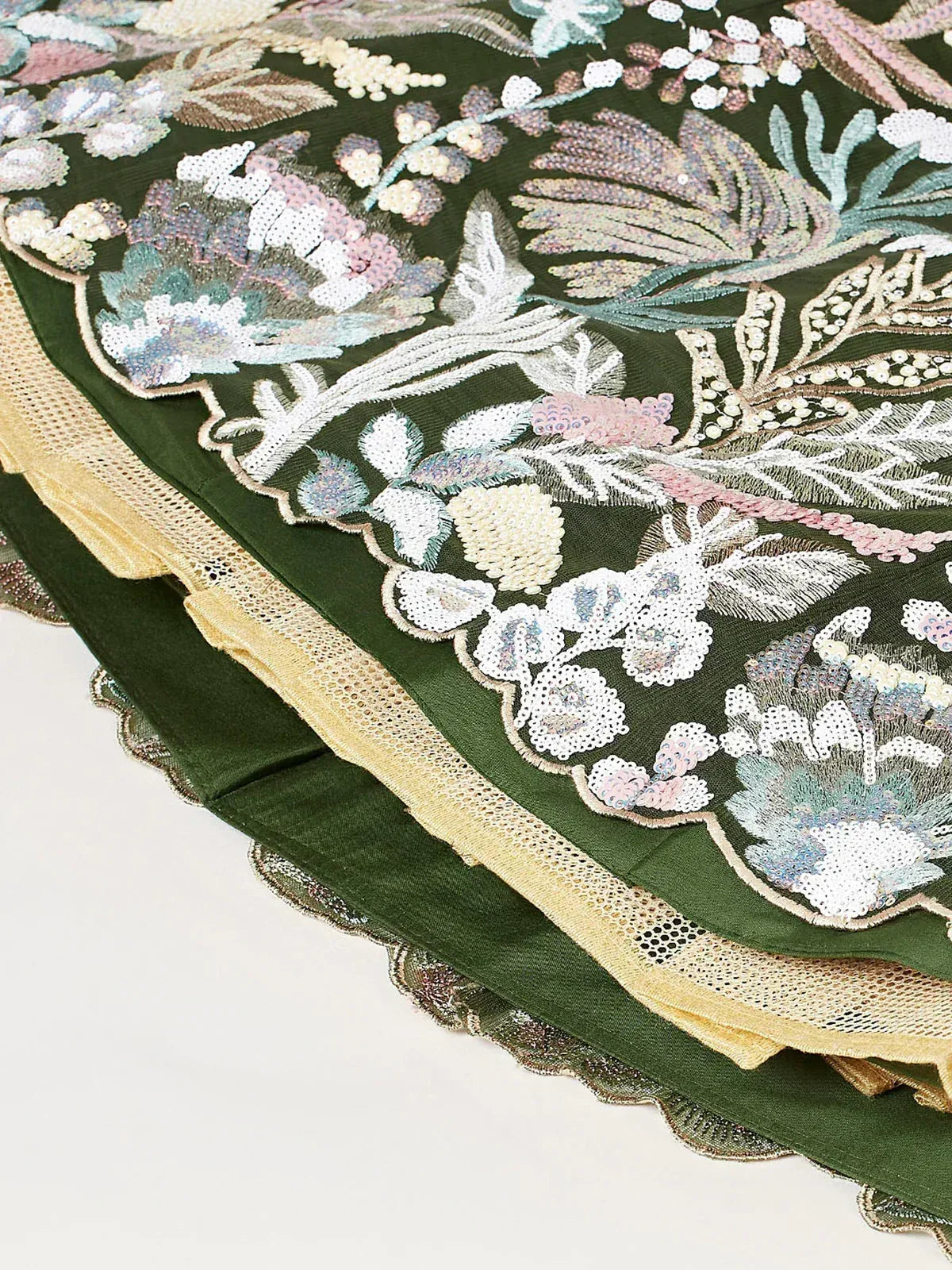 Emerald green lehenga with floral embroidery and sequin detailing, gold lace trim