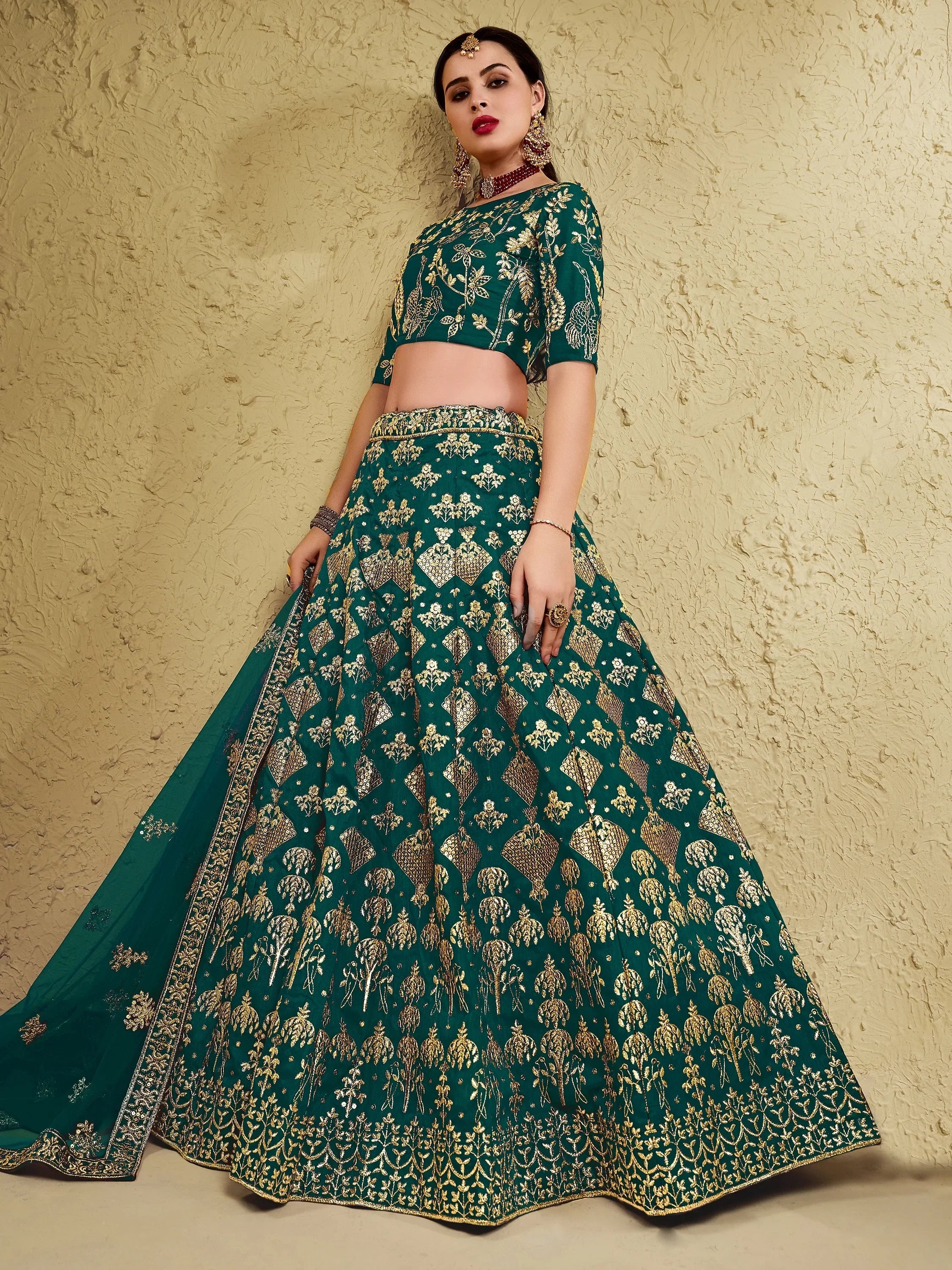 Emerald green lehenga choli with gold embroidery, perfect for Indian weddings and festive occasions.
