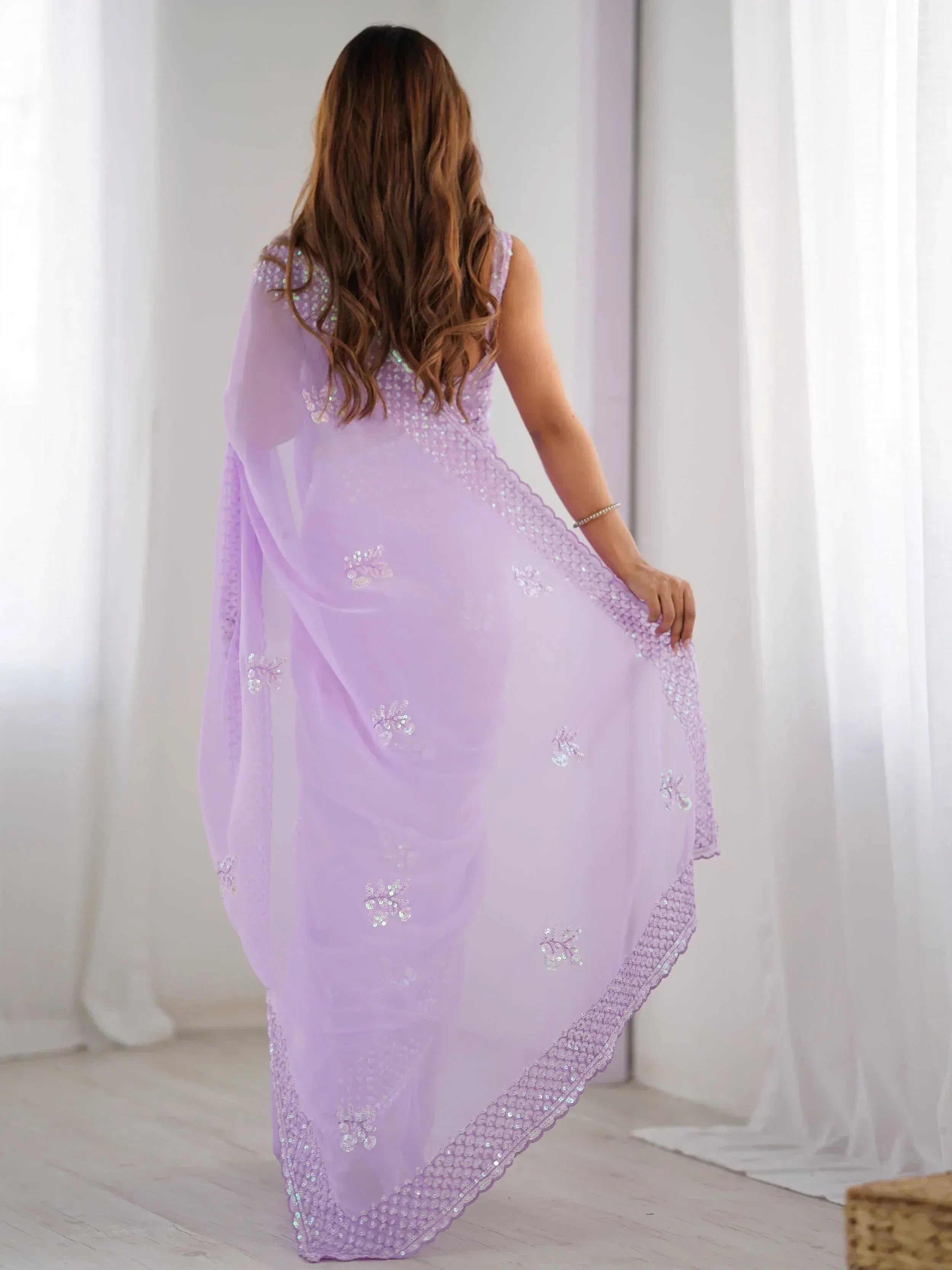 Lavender ethnic gown with sequin embroidery, perfect for Indian occasions and festive wear.