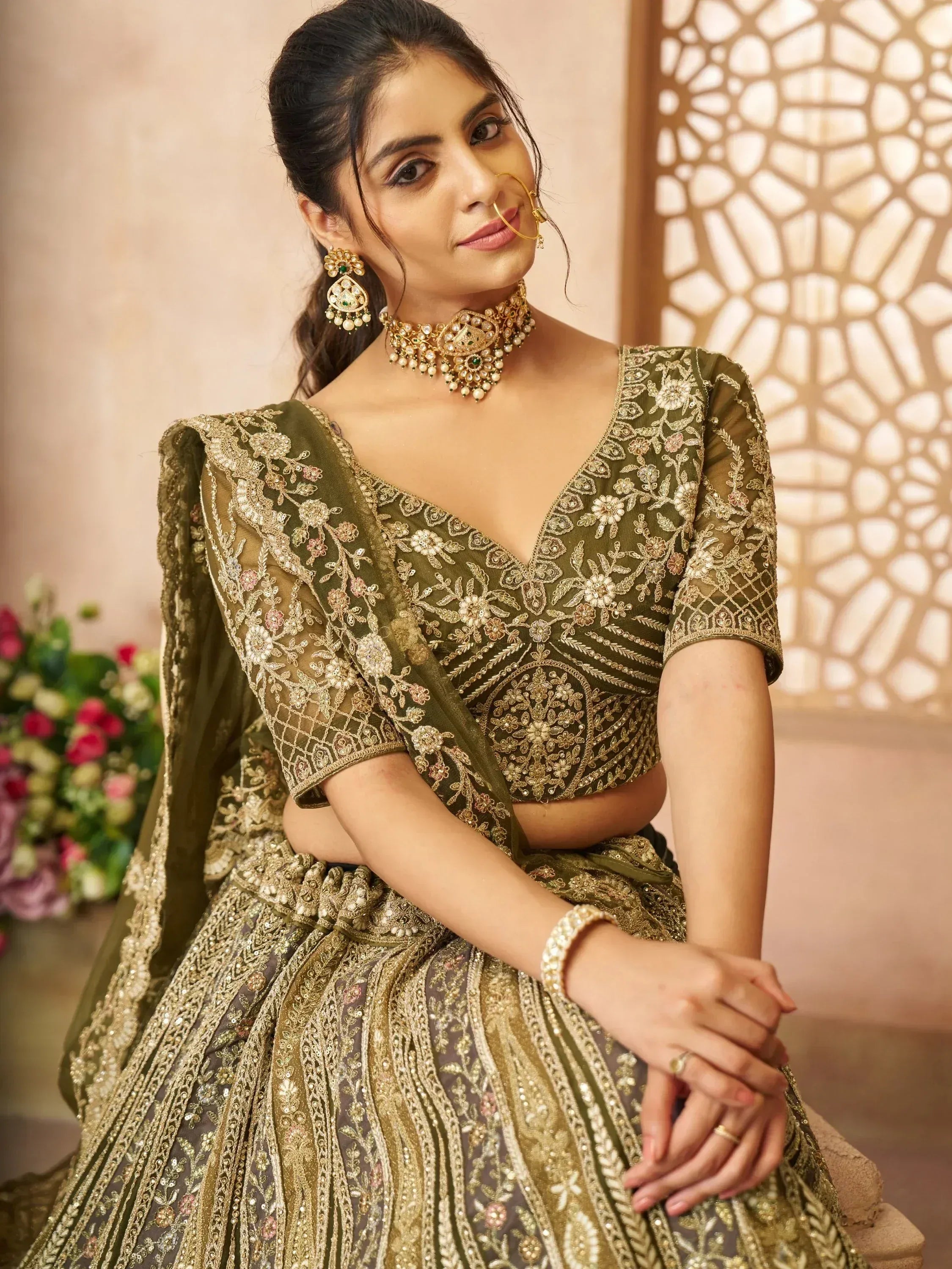 Olive green embroidered lehenga choli with gold detailing, perfect for Indian weddings and festive occasions.
