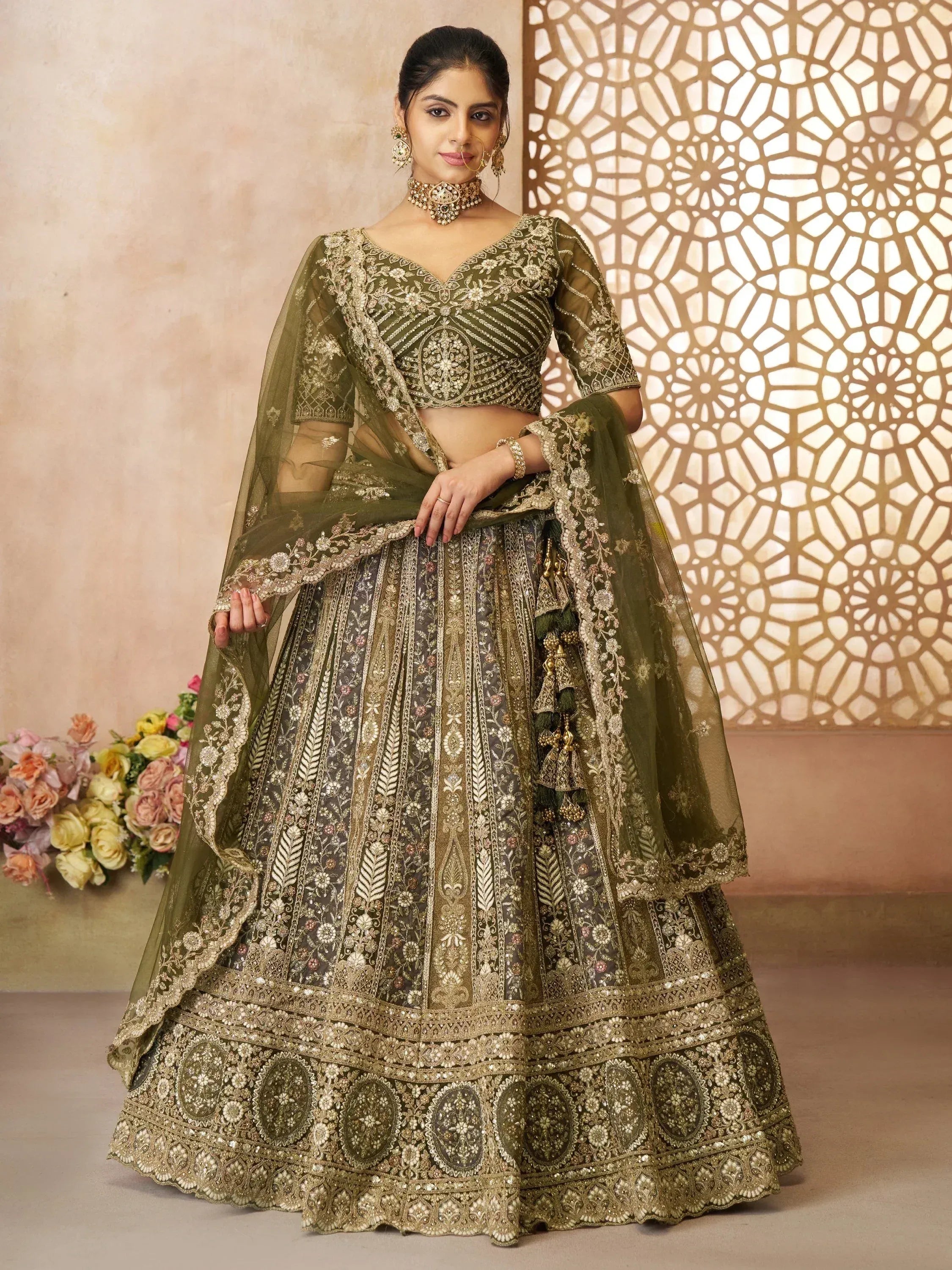 Olive green designer lehenga choli with heavy gold embroidery, perfect for weddings and festive occasions.