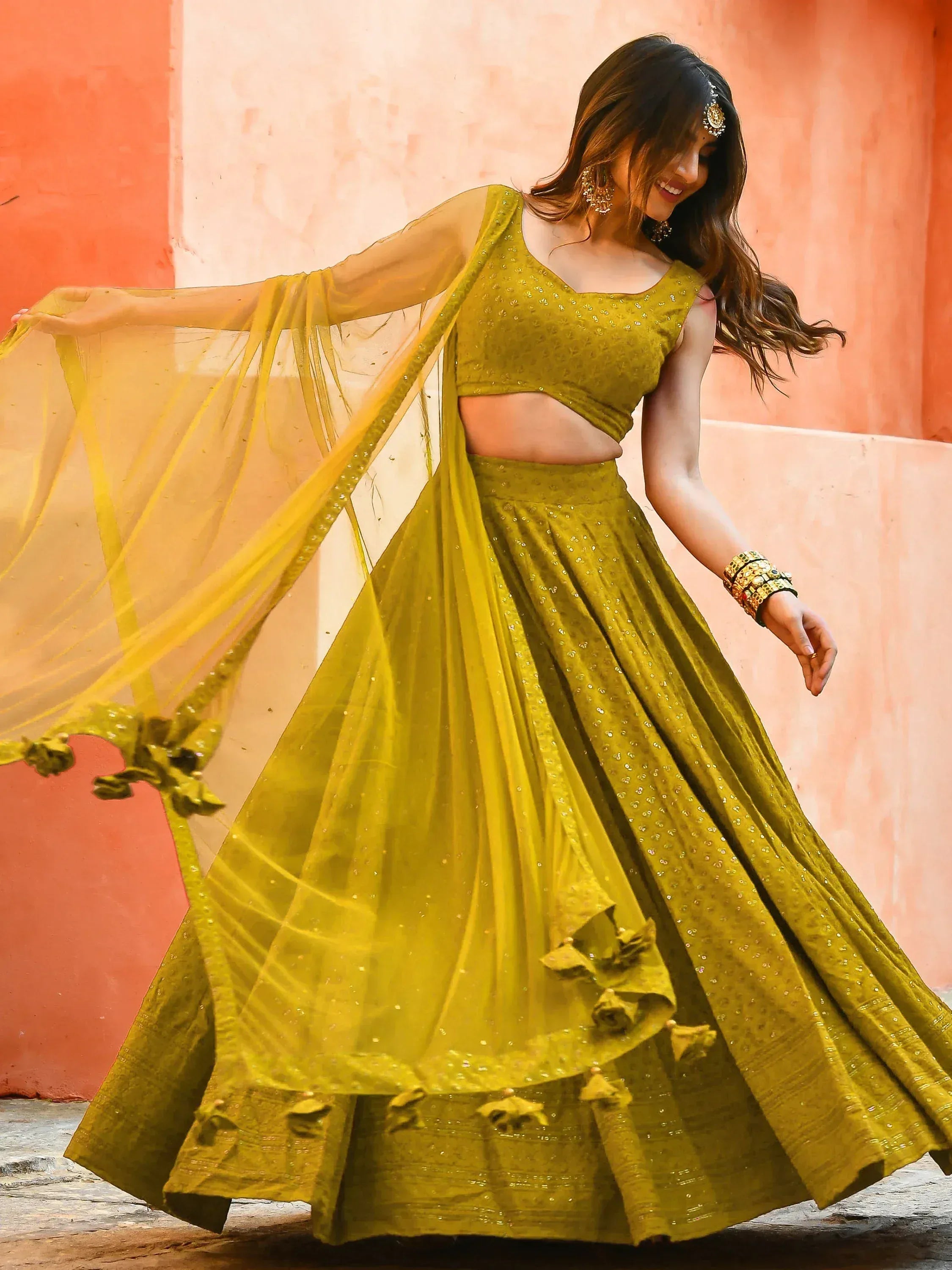 Olive green designer lehenga choli with sequins, sheer dupatta, and floral tassels for Indian ethnic wear
