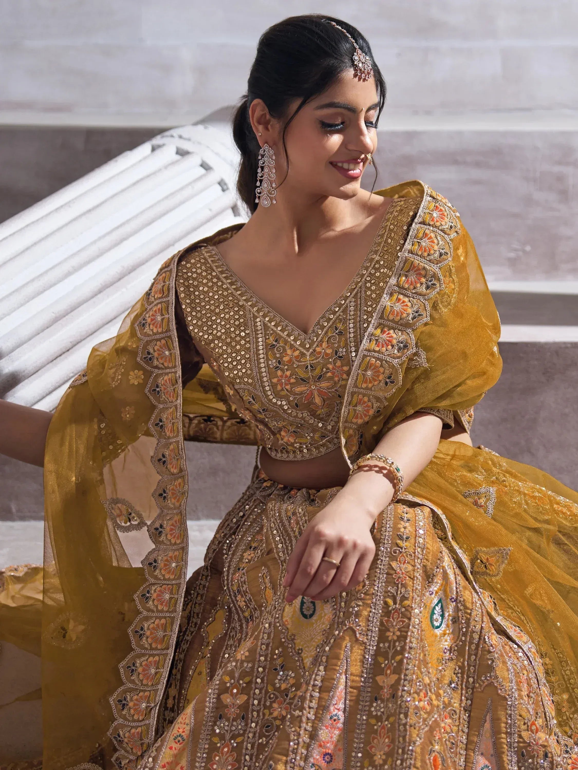 Elegant mustard yellow lehenga choli with floral embroidery and mirror work, perfect for Indian weddings and festive occasions.