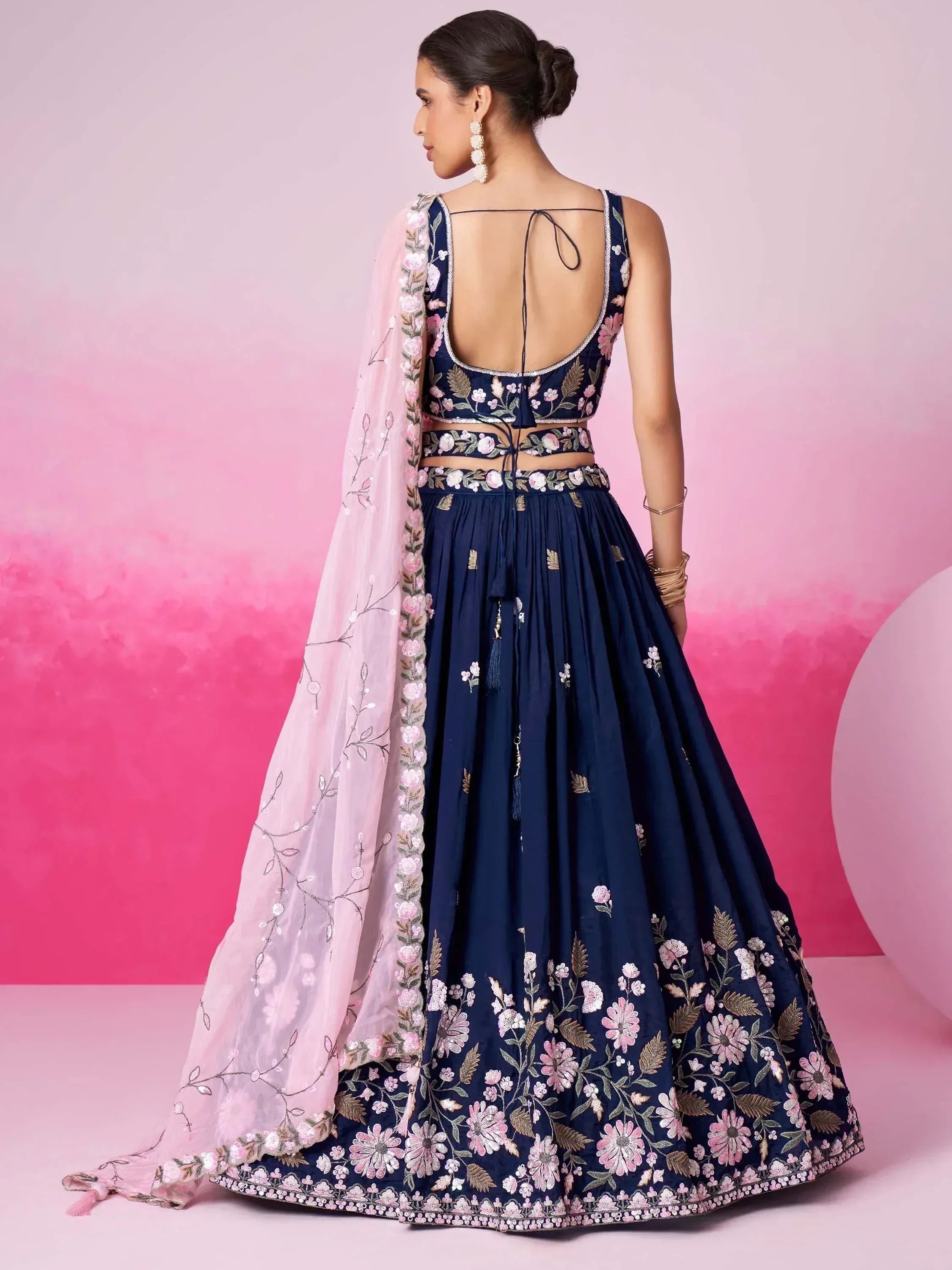 Navy blue floral embroidered lehenga choli with pink dupatta, back view