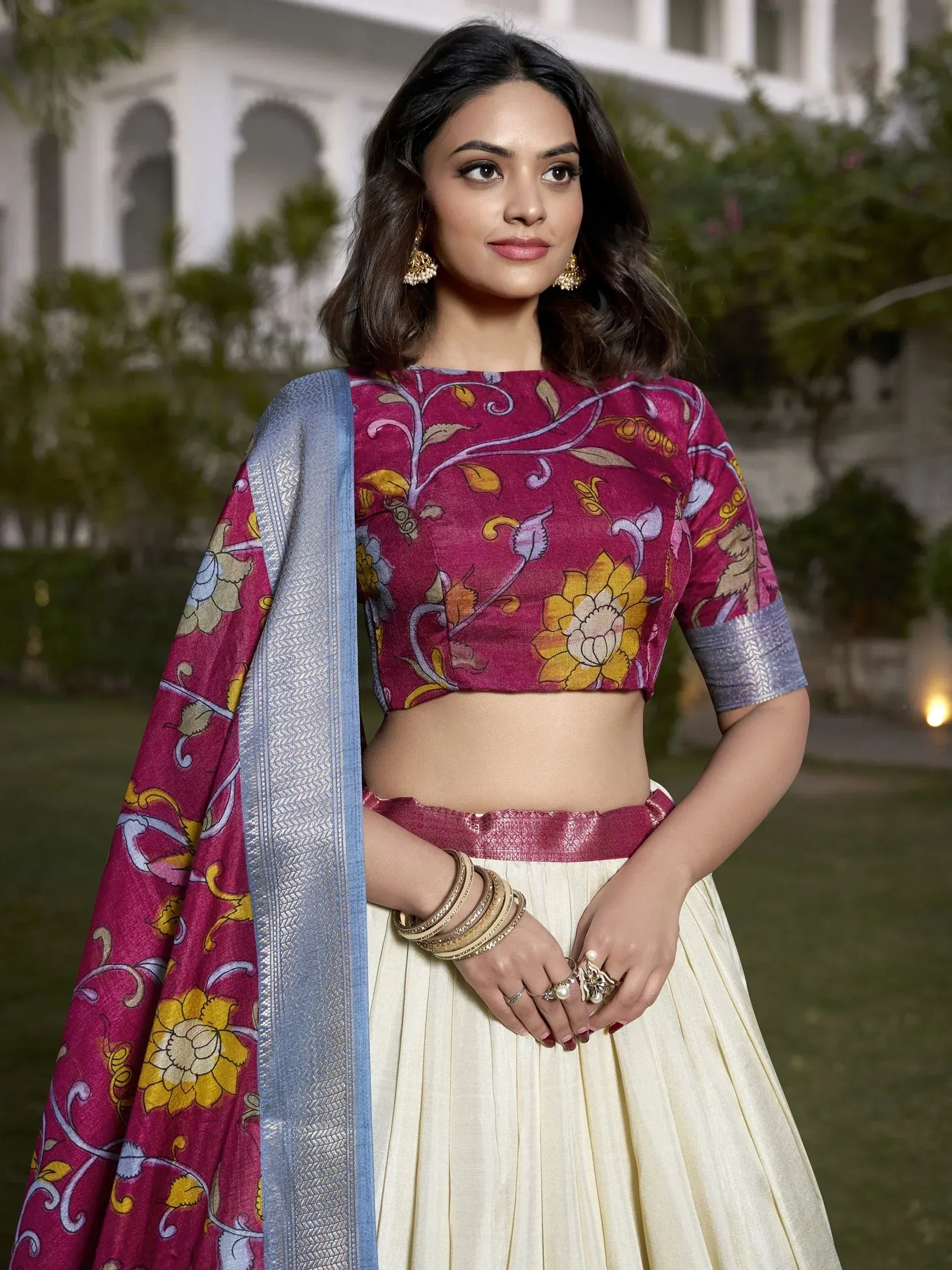 Woman in maroon floral crop top with cream pleated skirt and blue dupatta, Indian ethnic wear