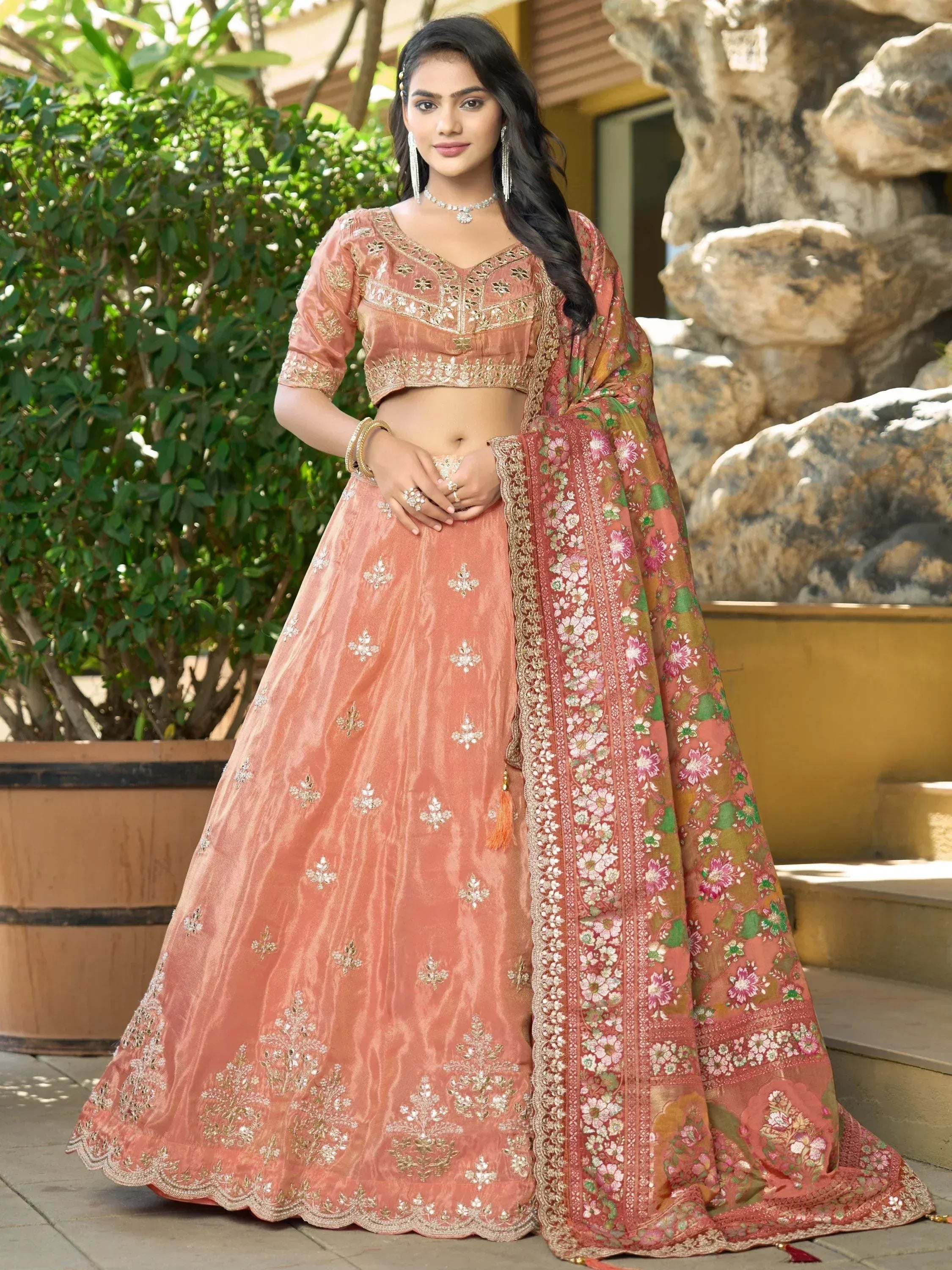 Peach designer lehenga choli with floral dupatta, perfect for Indian weddings and festive occasions.