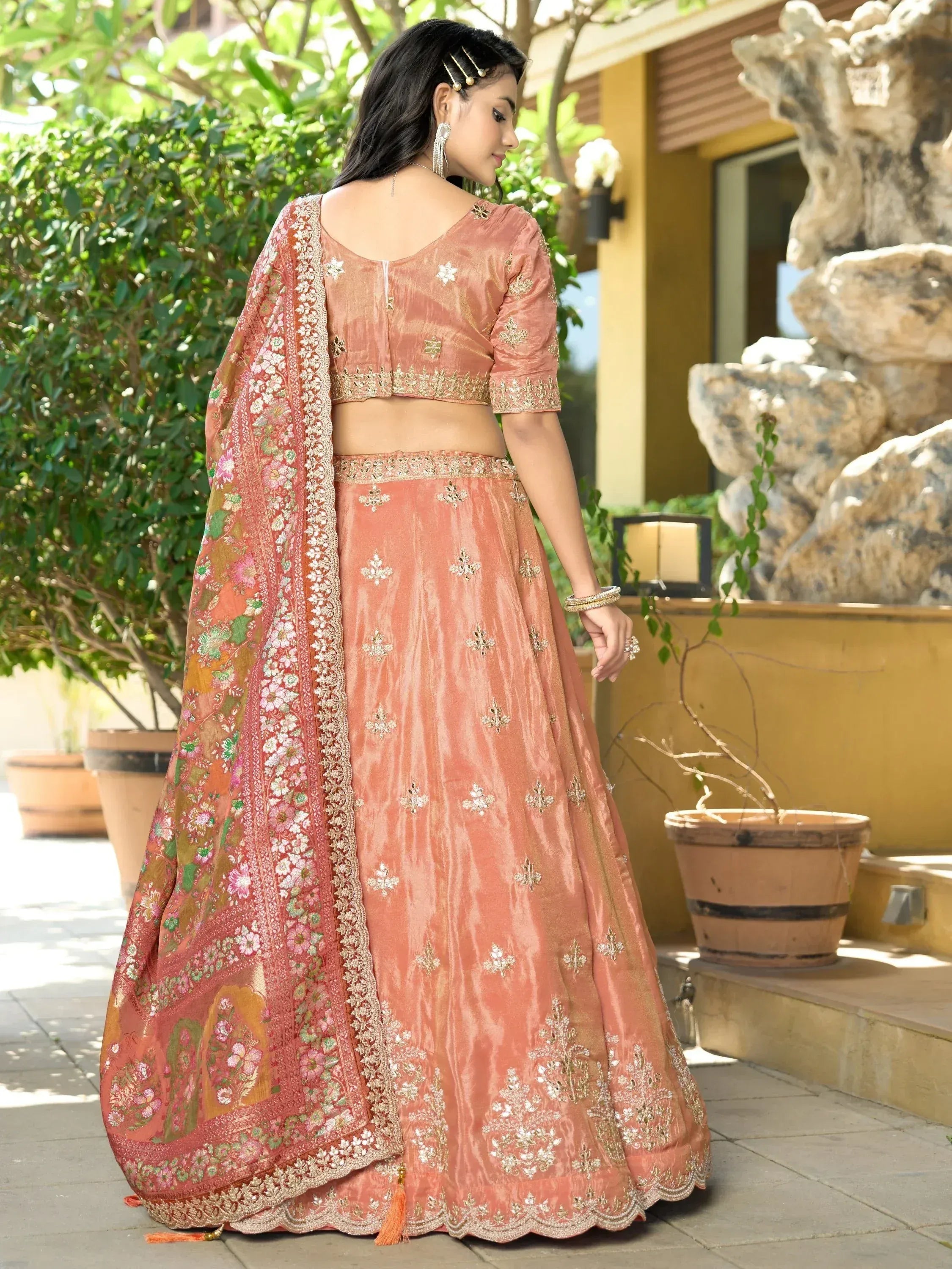 Peach designer lehenga choli with floral dupatta, perfect for Indian ethnic wear occasions