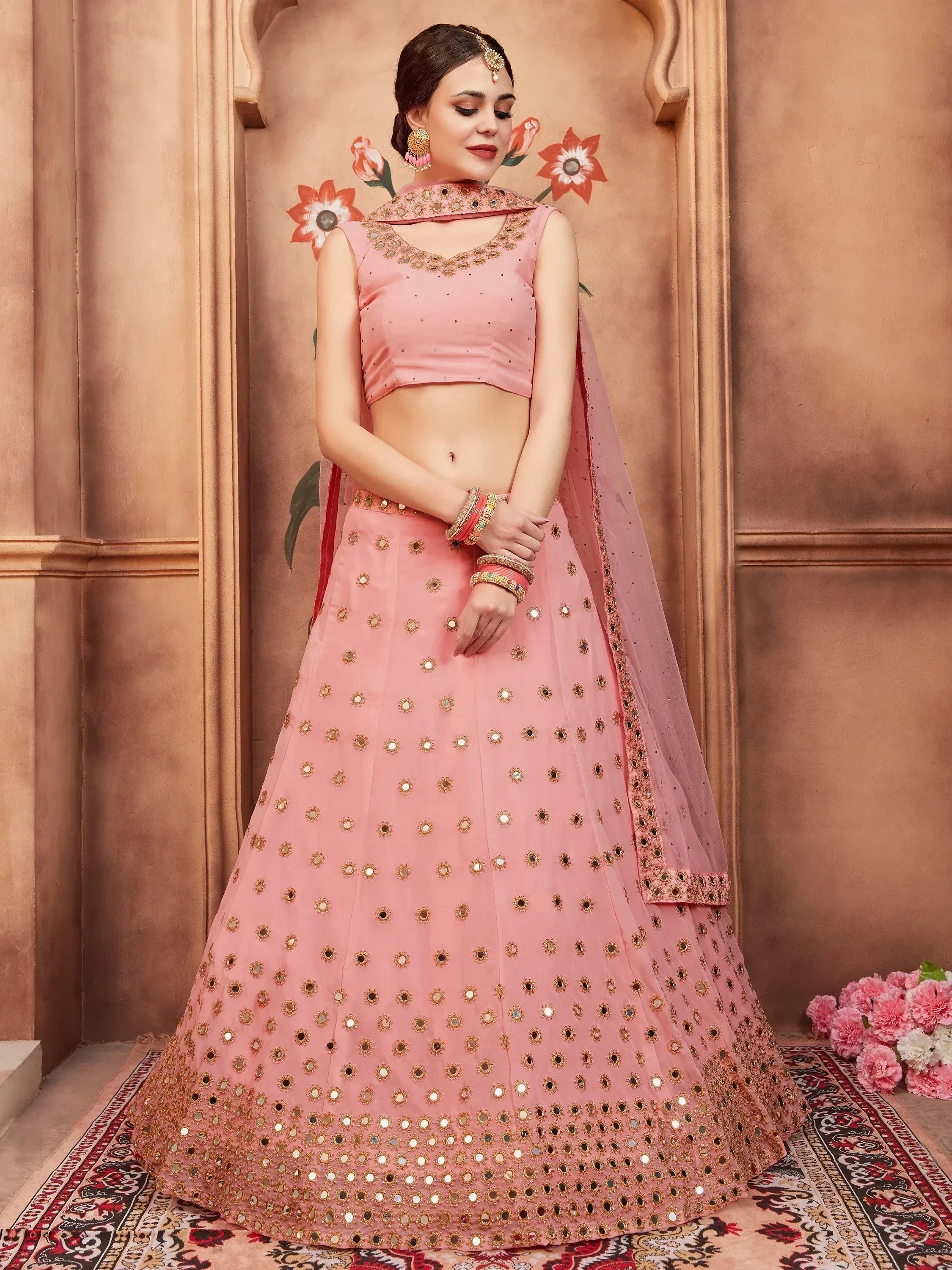 Pink mirror-work lehenga choli with gold embroidery, perfect for Indian ethnic wear occasions