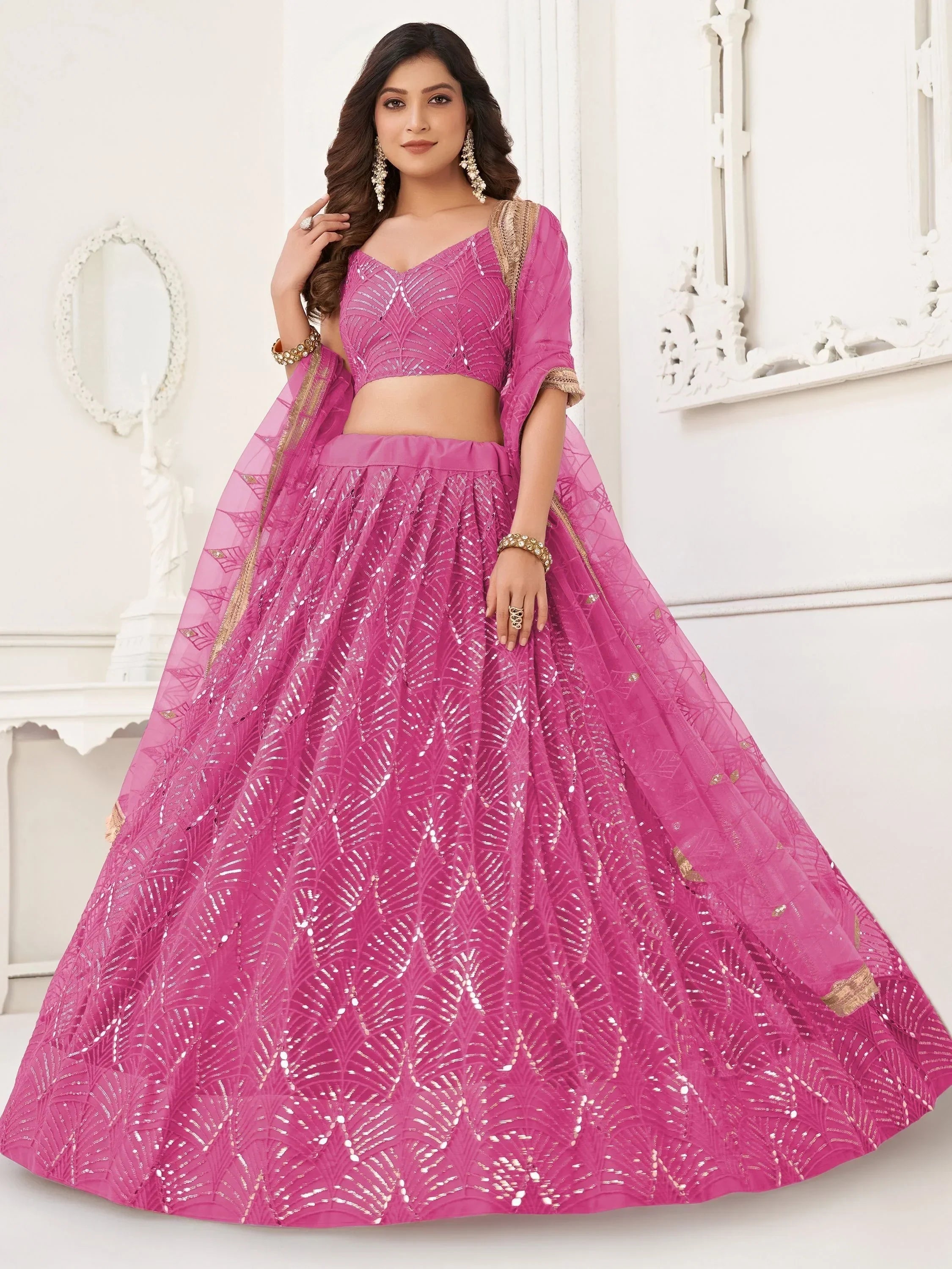 Pink designer lehenga choli with sequin embroidery and gold trim, perfect for Indian ethnic wear occasions.