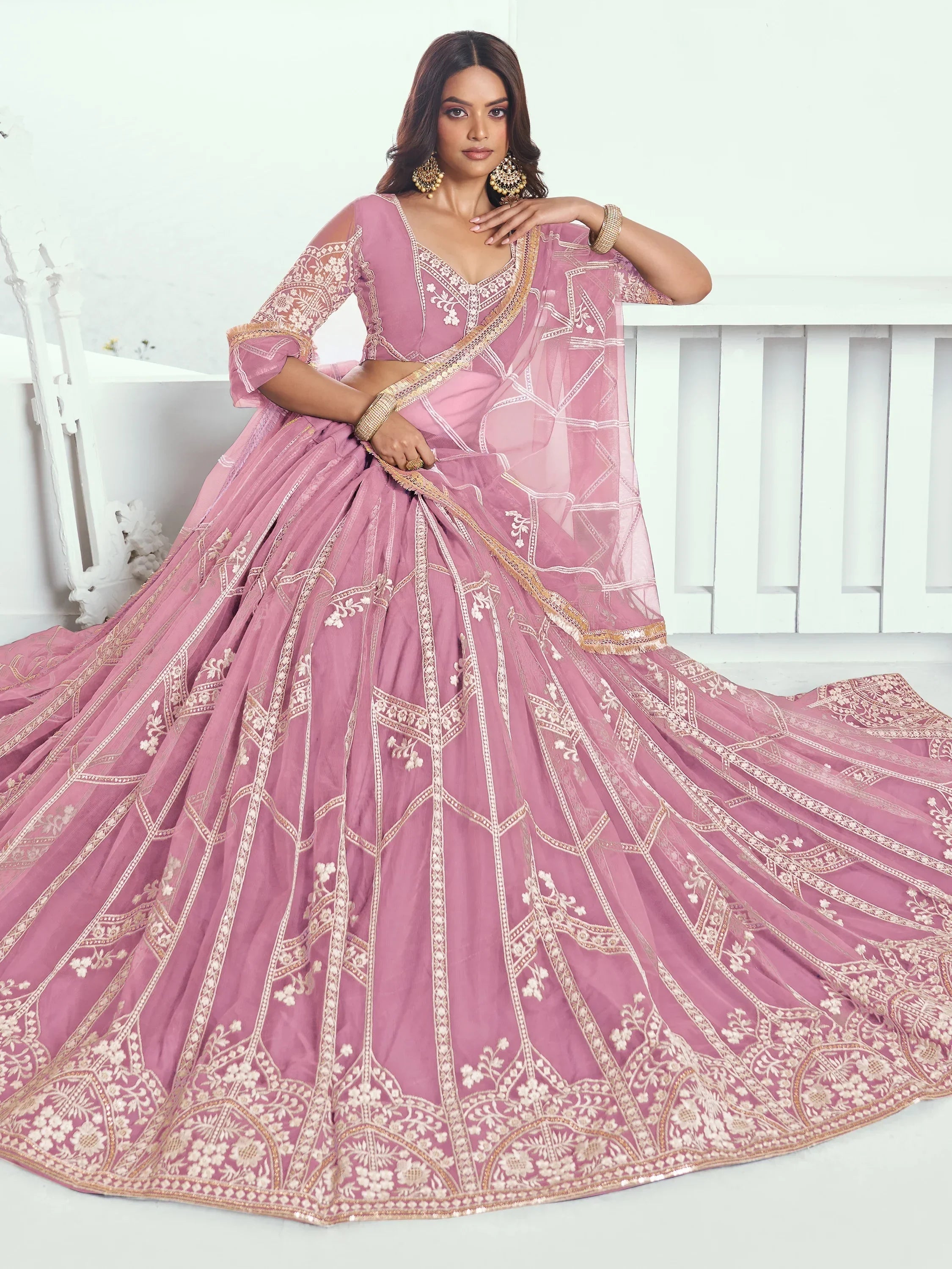 Pink designer lehenga choli with gold embroidery, perfect for weddings and festive occasions
