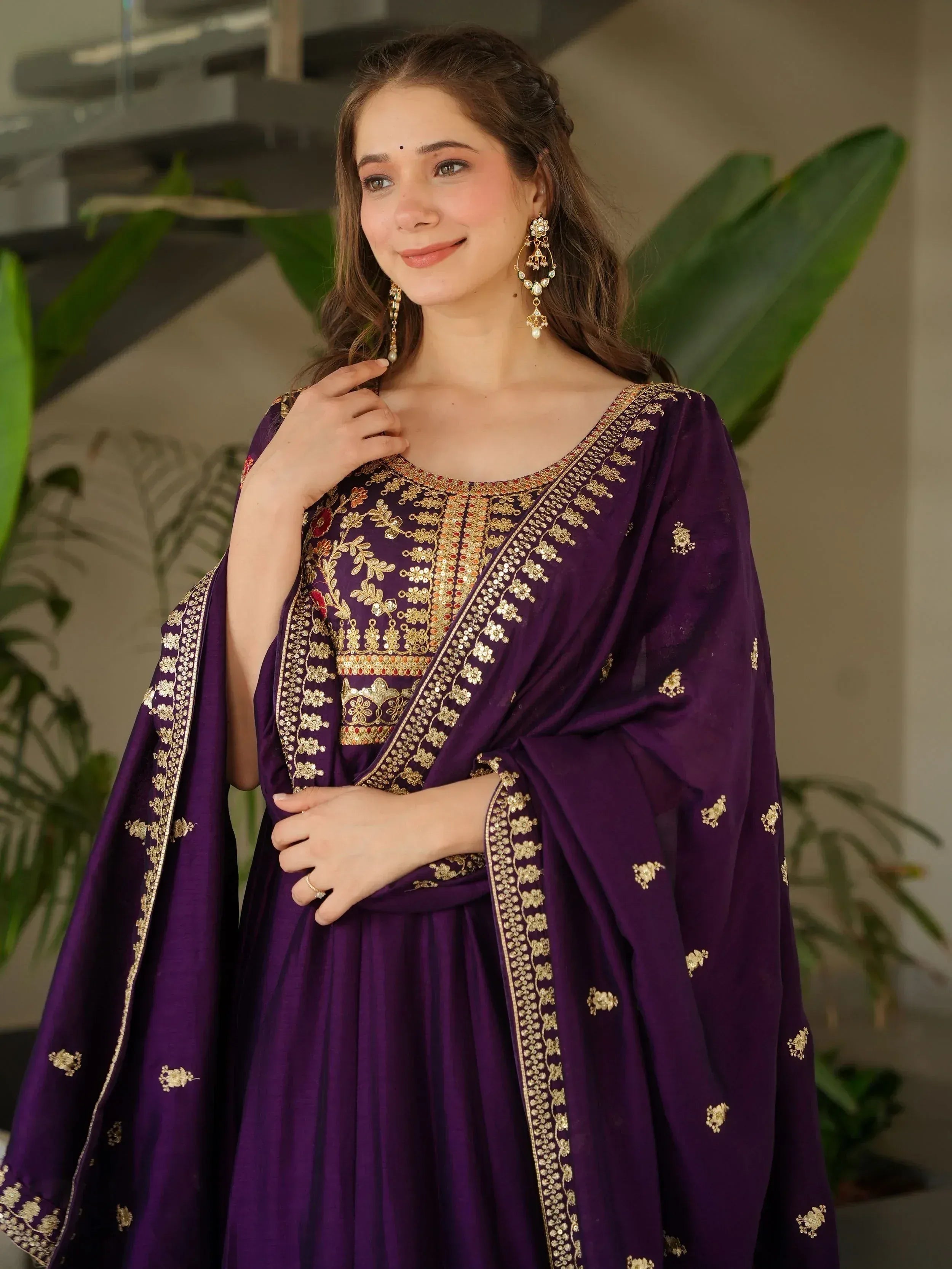 Purple ethnic gown with gold embroidery, perfect for Indian occasions and festive wear.