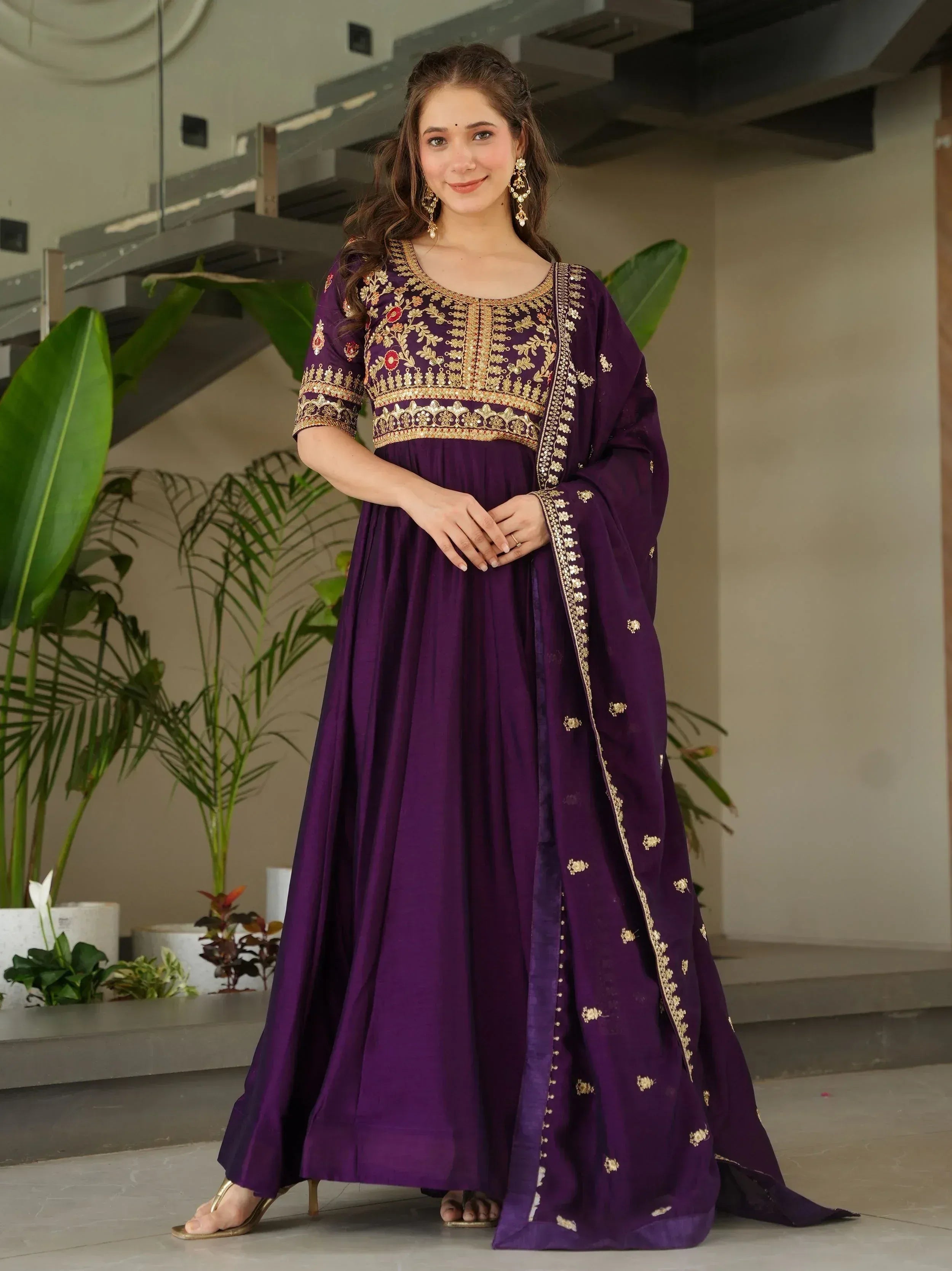 Purple embroidered Anarkali suit with gold detailing, perfect for Indian ethnic wear occasions.