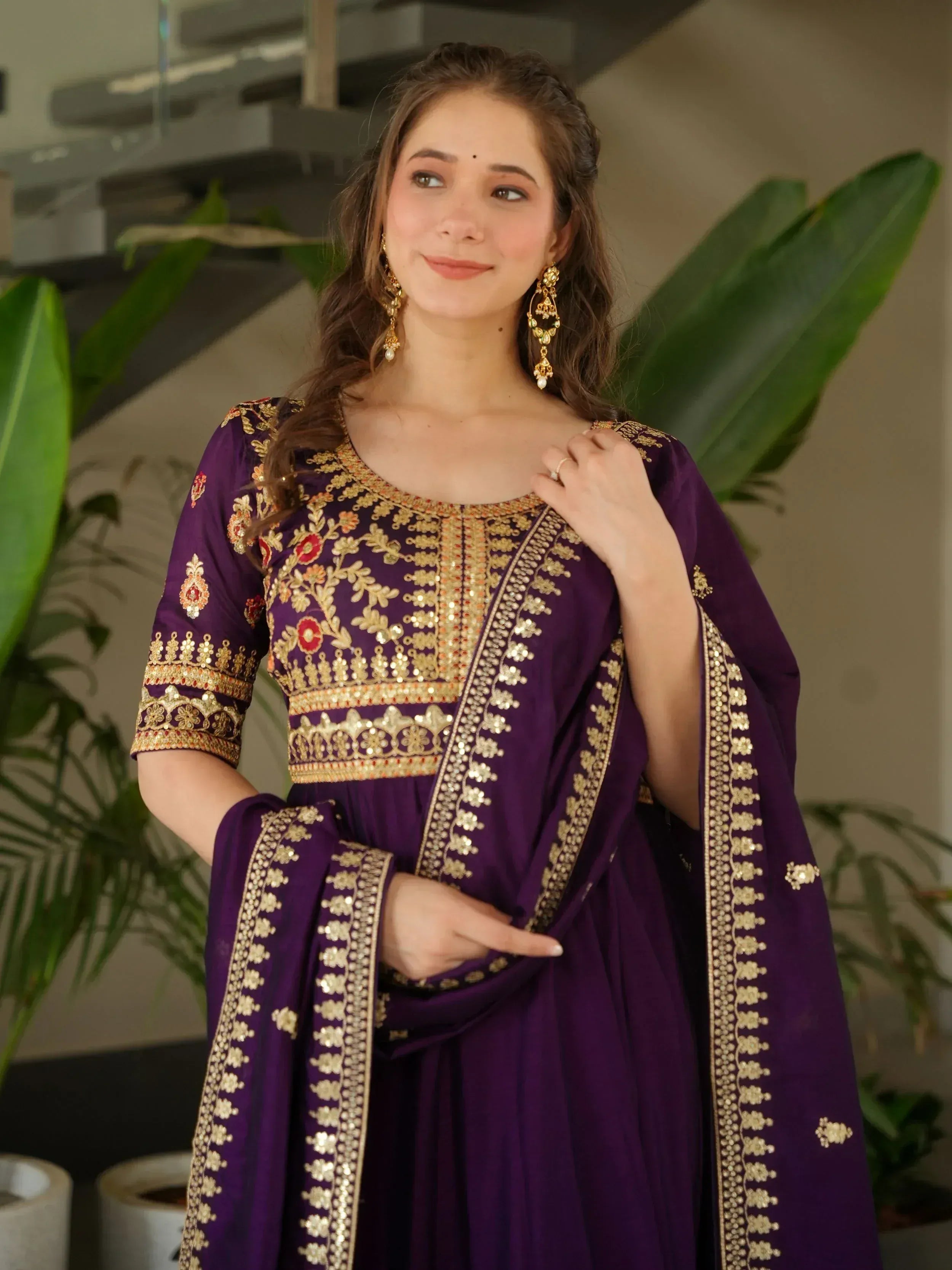 Purple ethnic gown with gold embroidery and floral details, perfect for Indian festive occasions