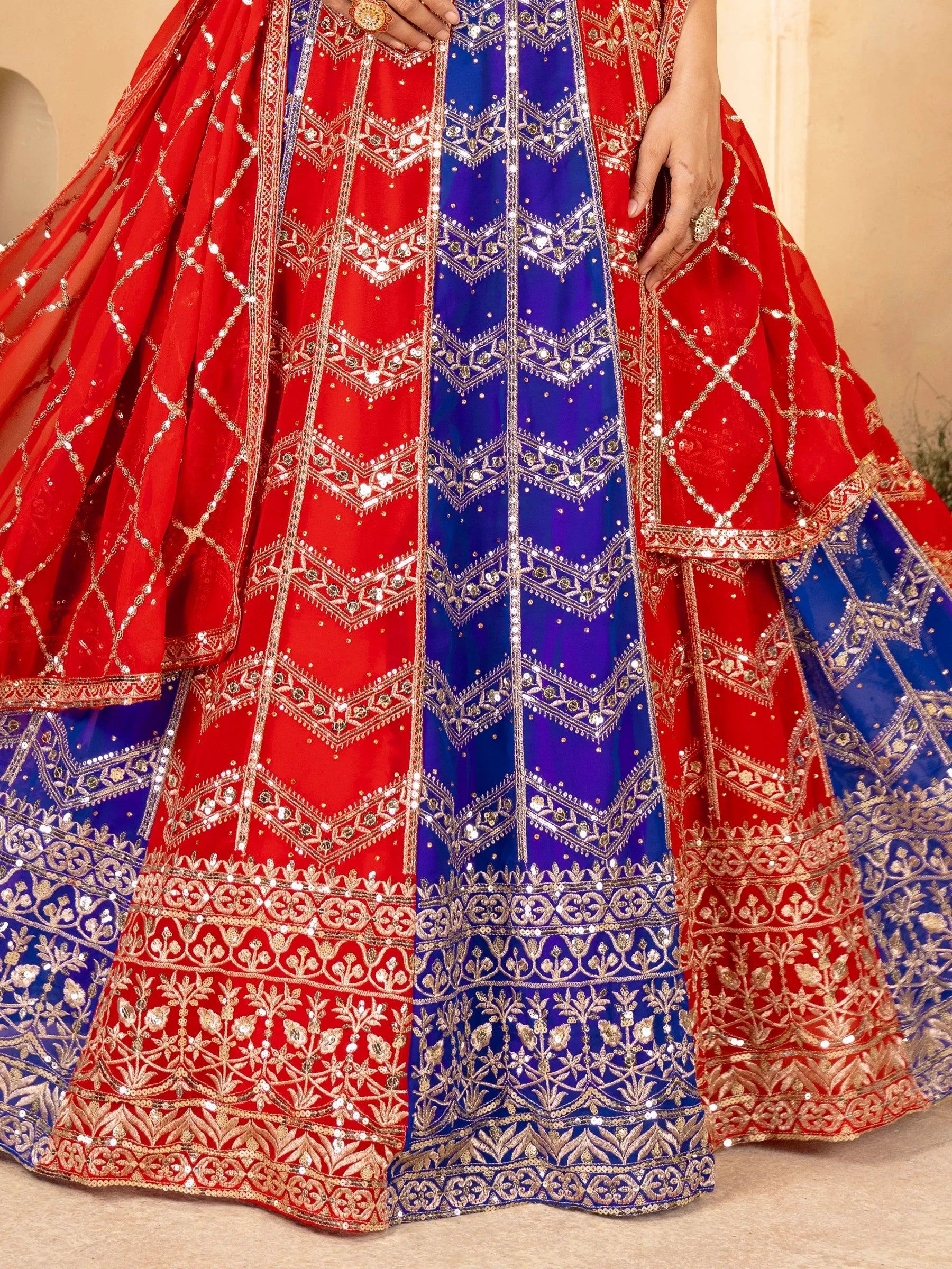 Red and blue designer lehenga choli with intricate gold embroidery and sequin work for Indian ethnic wear