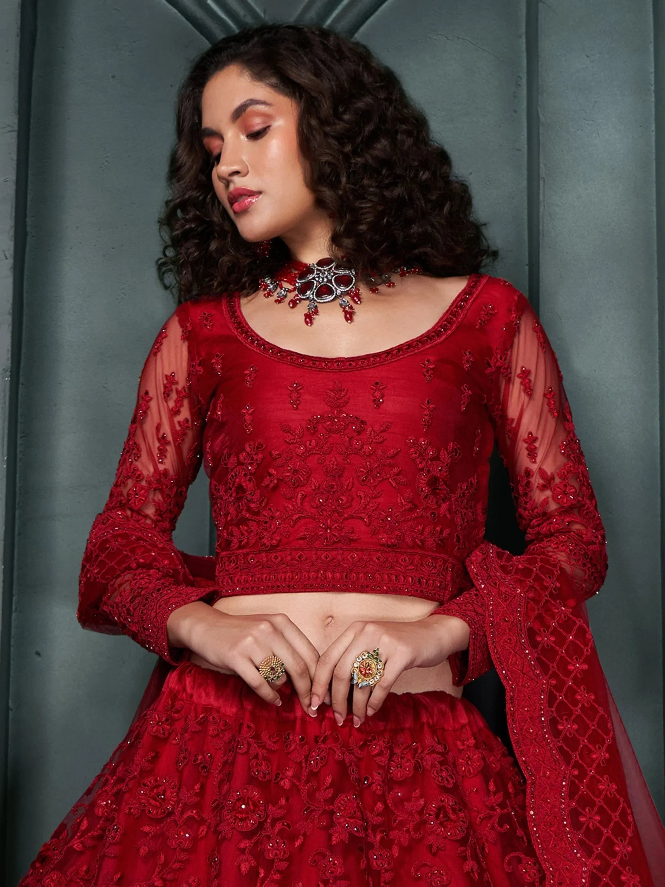 Red embroidered lehenga choli with sheer sleeves, perfect for Indian weddings and festive occasions