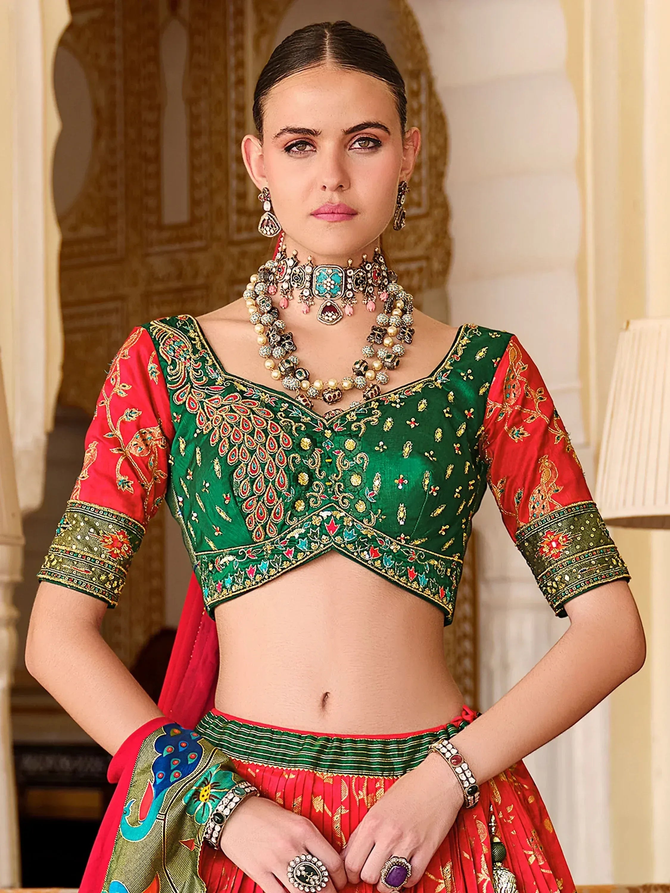 Green and red embroidered lehenga choli with peacock motifs, traditional Indian ethnic wear