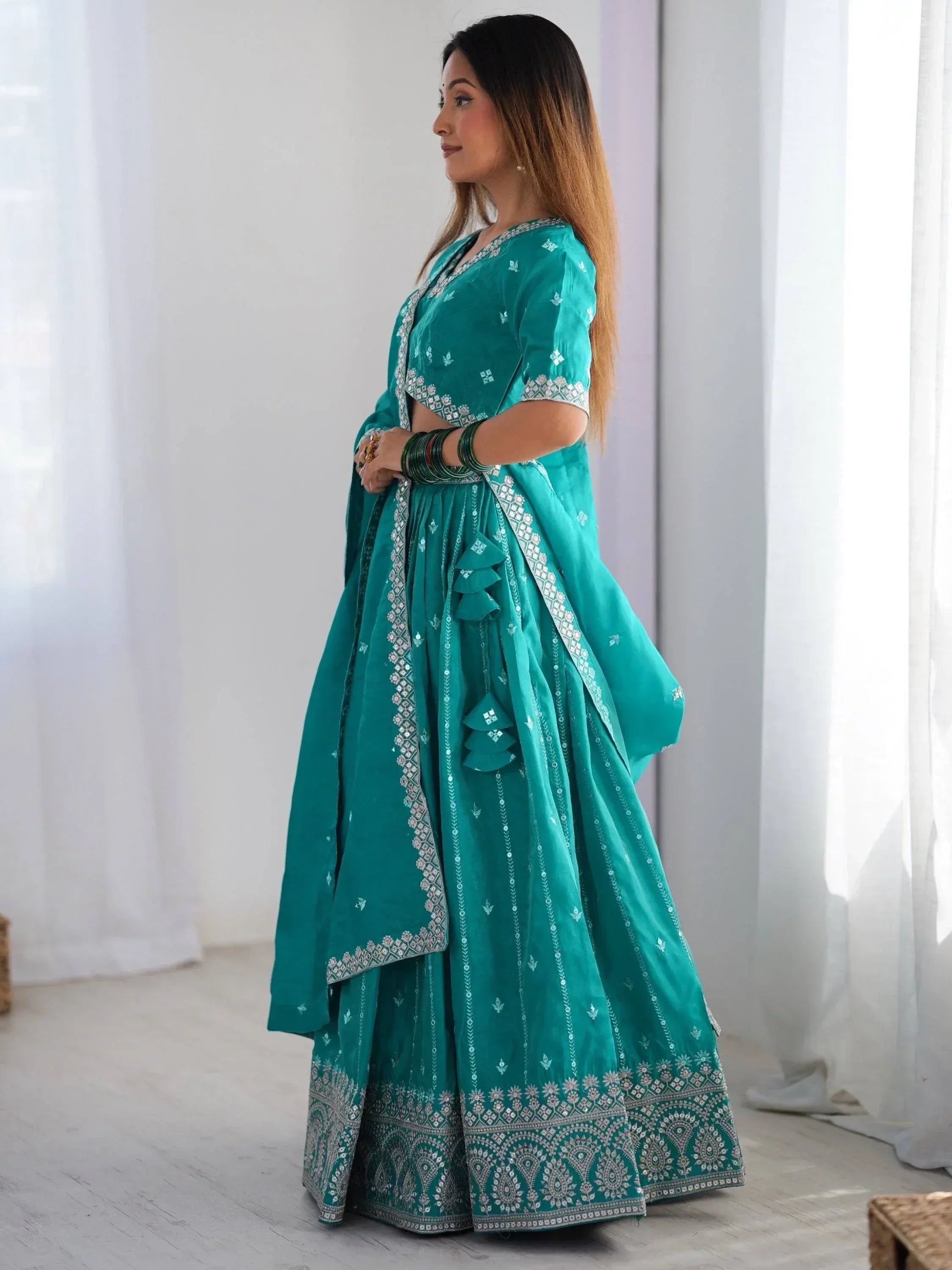 Teal green designer lehenga choli with silver embroidery, perfect for Indian ethnic wear occasions