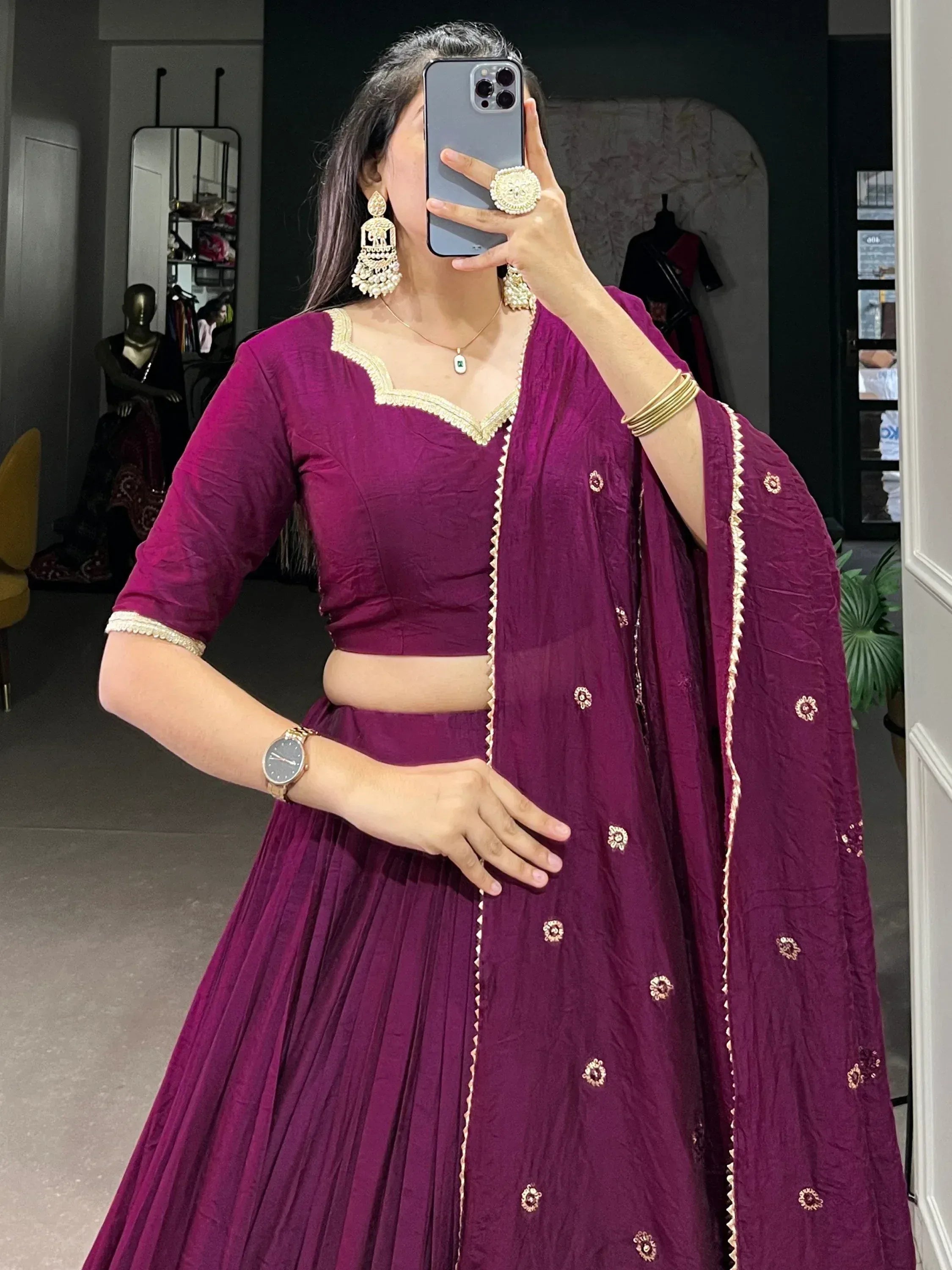 Purple ethnic lehenga choli with gold embroidery, mirror selfie in boutique