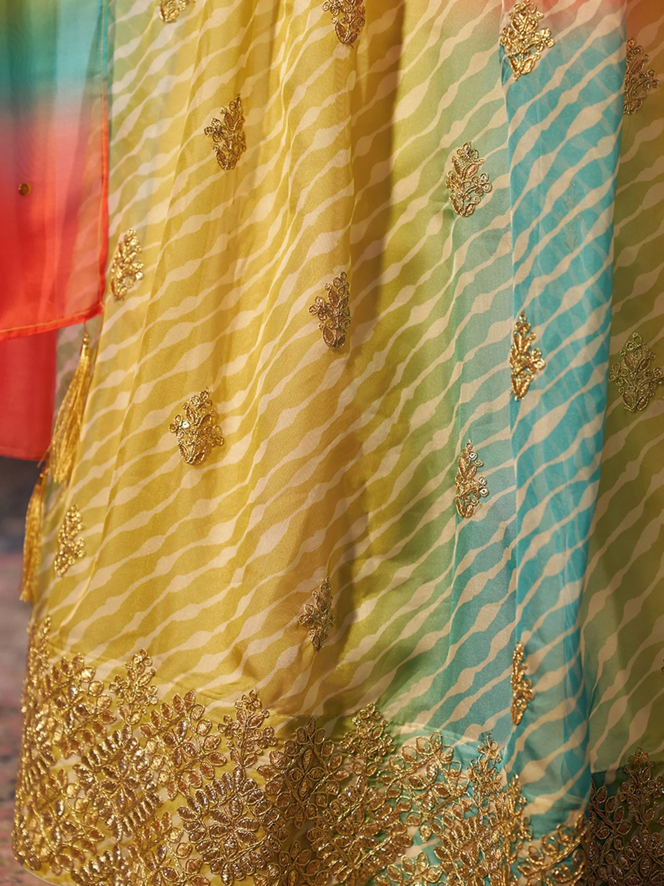 Colorful ethnic gown with gold embroidery and zebra print, perfect for Indian festive wear