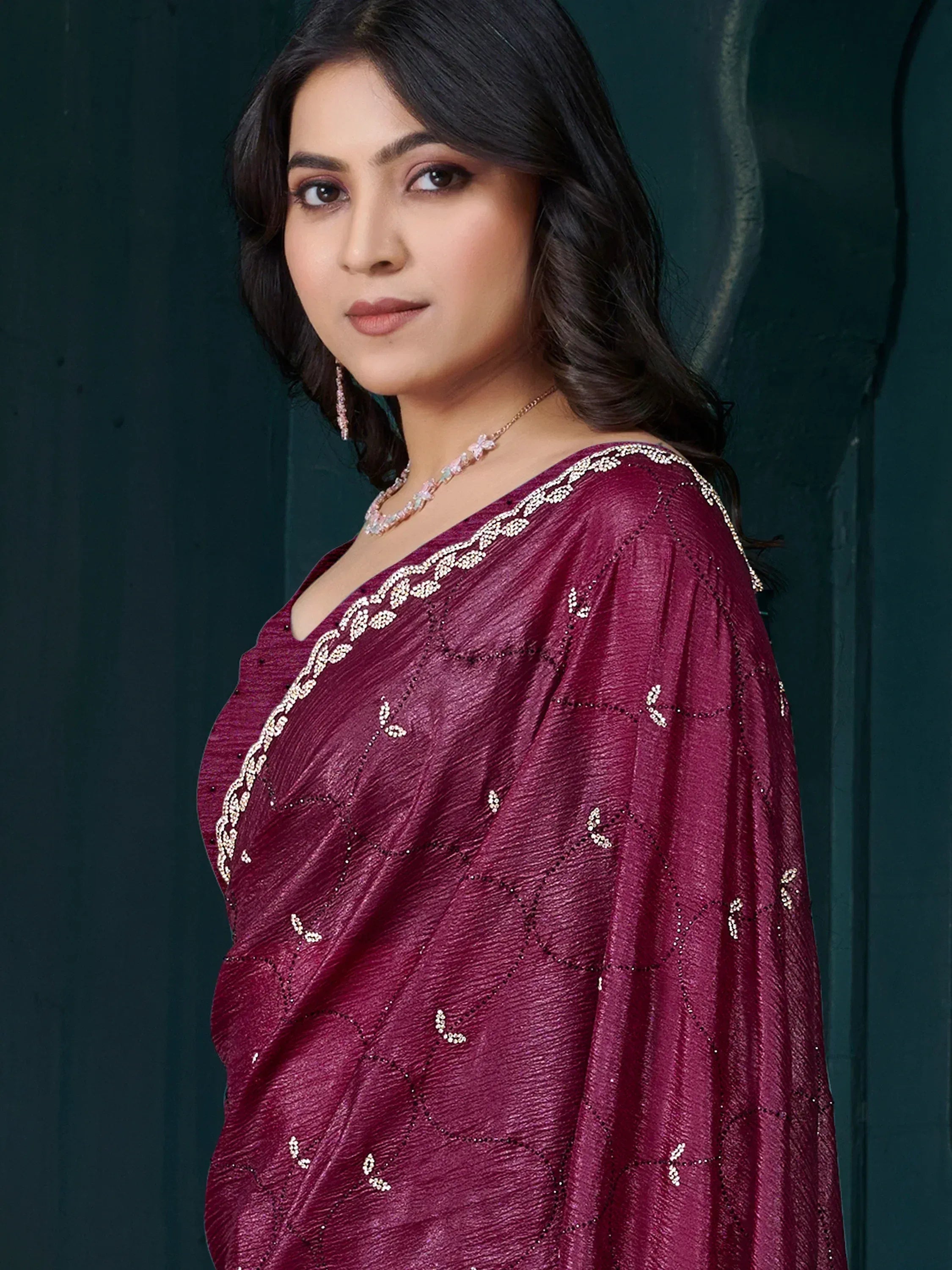 Woman in maroon ethnic gown with sequin embroidery, perfect for Indian occasions and festive wear.
