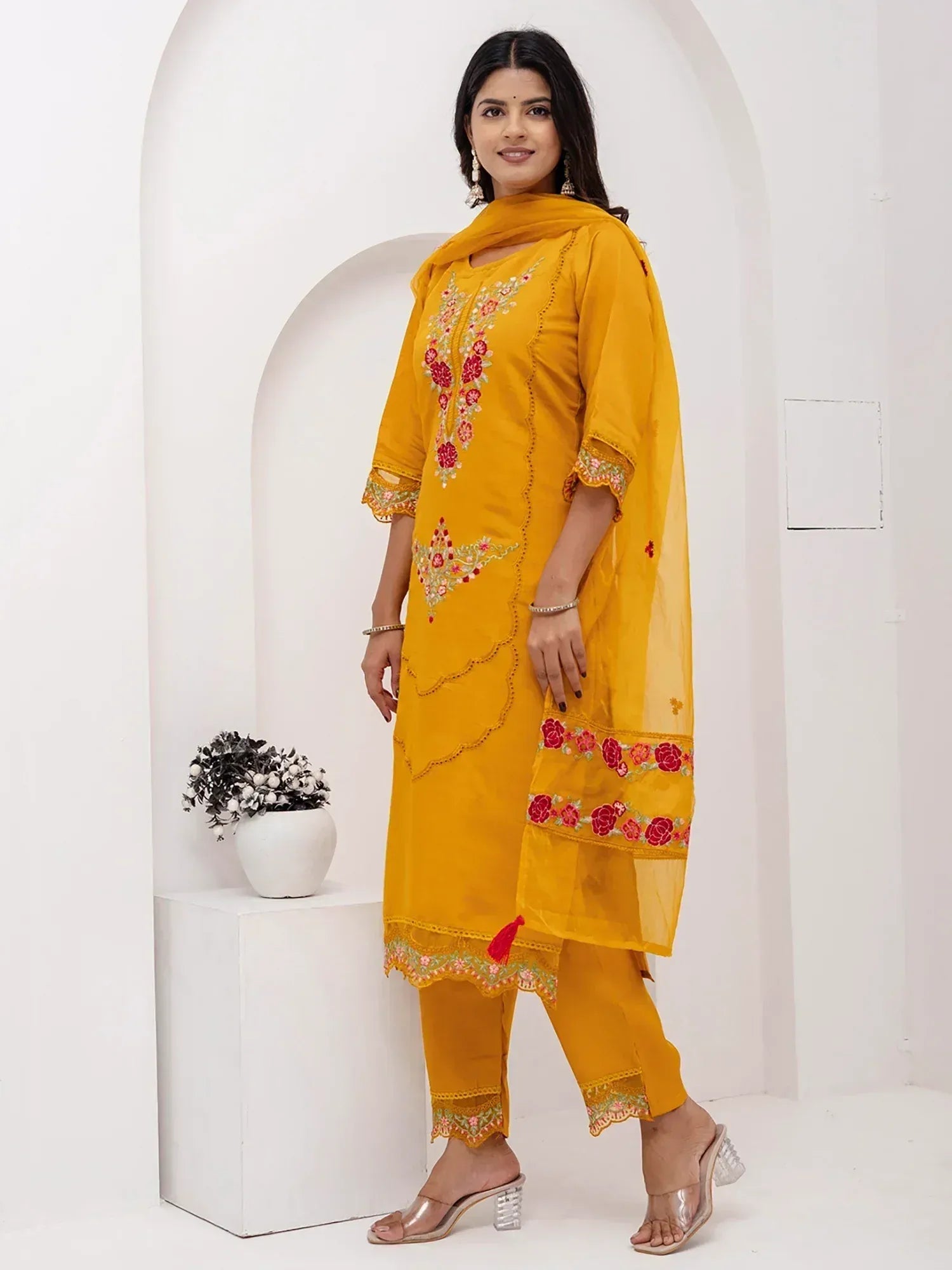 Yellow embroidered salwar kameez with floral design, perfect for ethnic wear and festive occasions.