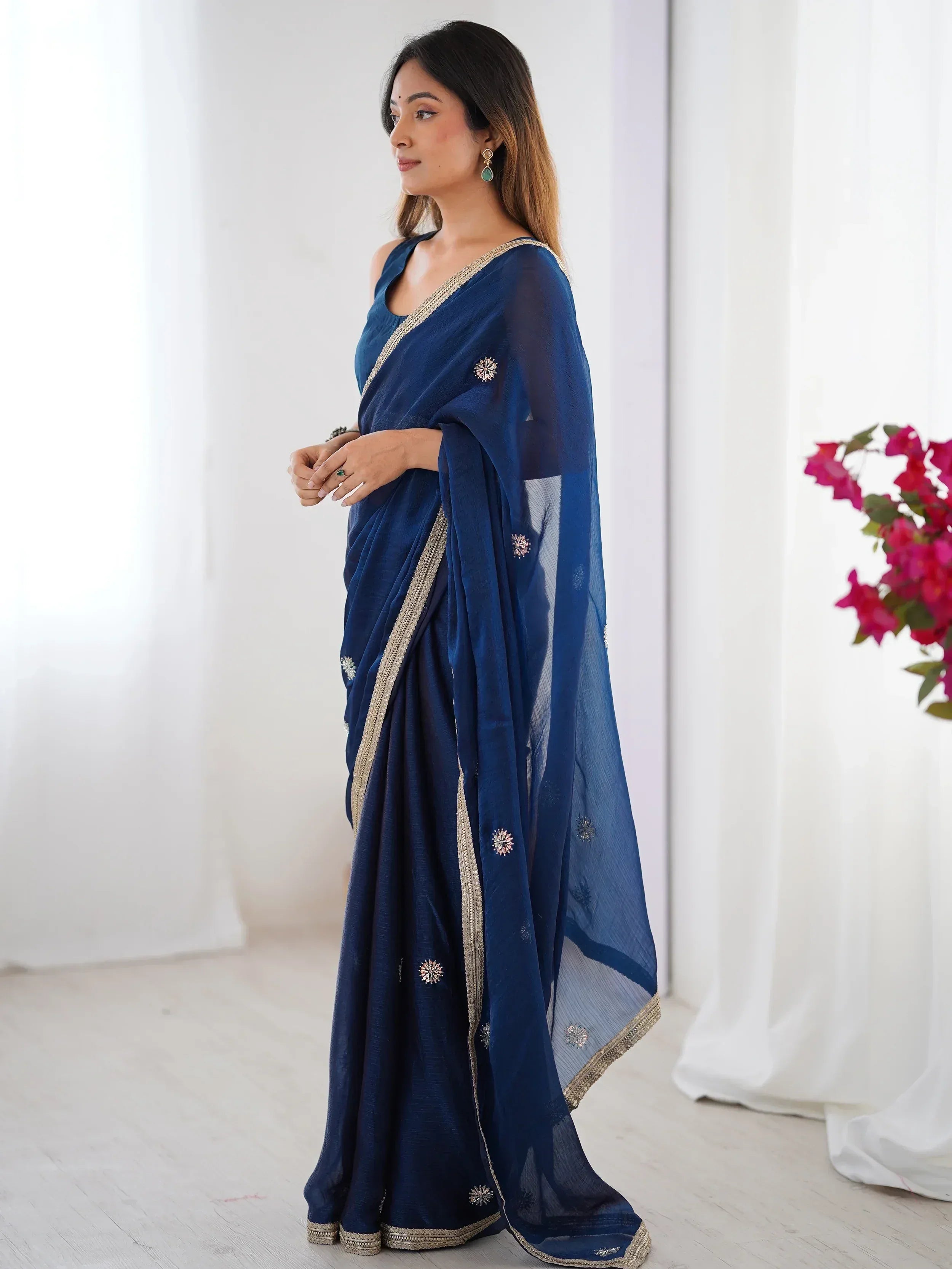 Navy blue designer saree with gold border and floral embroidery, perfect for Indian ethnic wear occasions