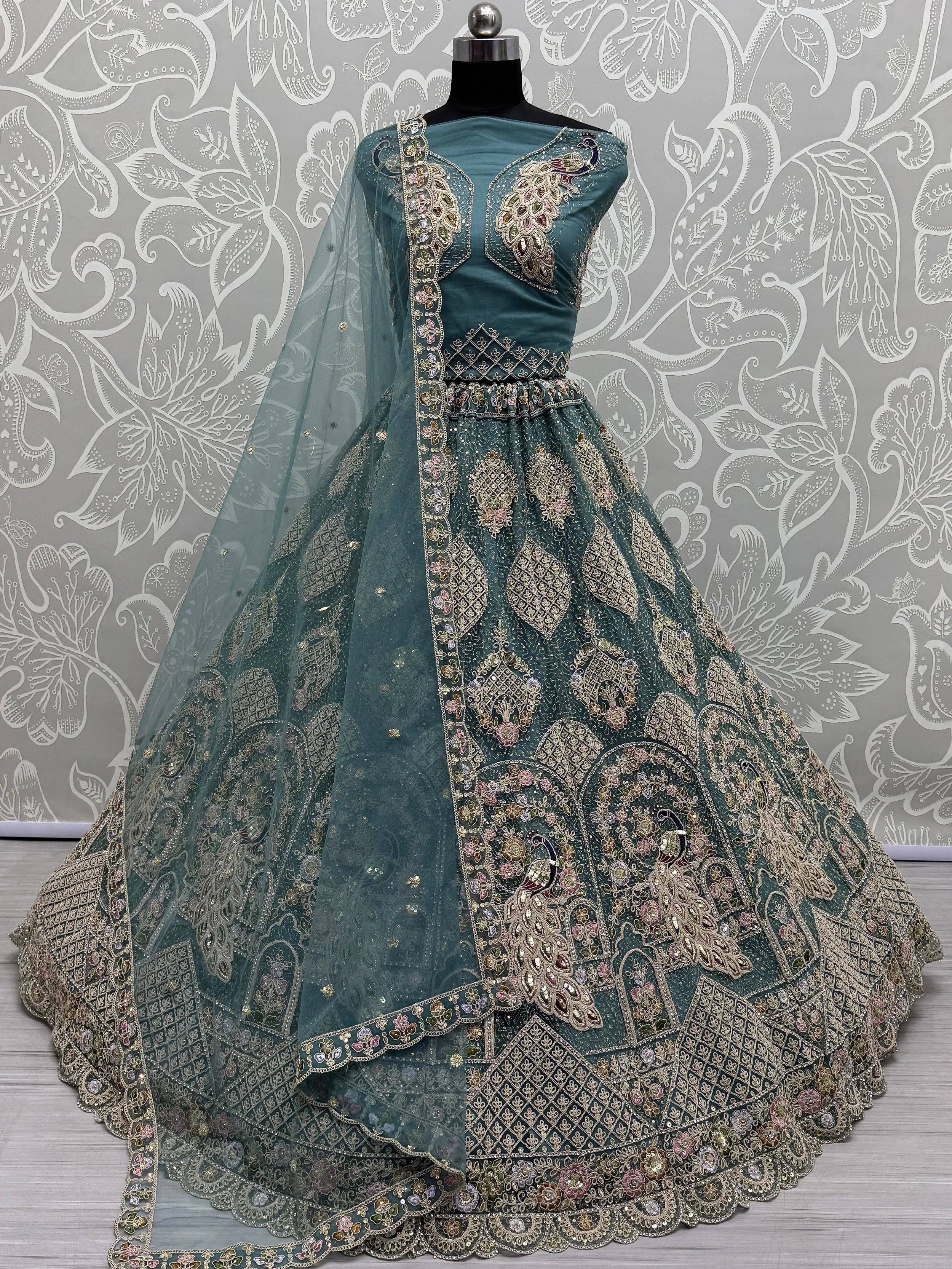 Teal designer lehenga choli with peacock embroidery and gold detailing, perfect for Indian weddings and festive occasions.