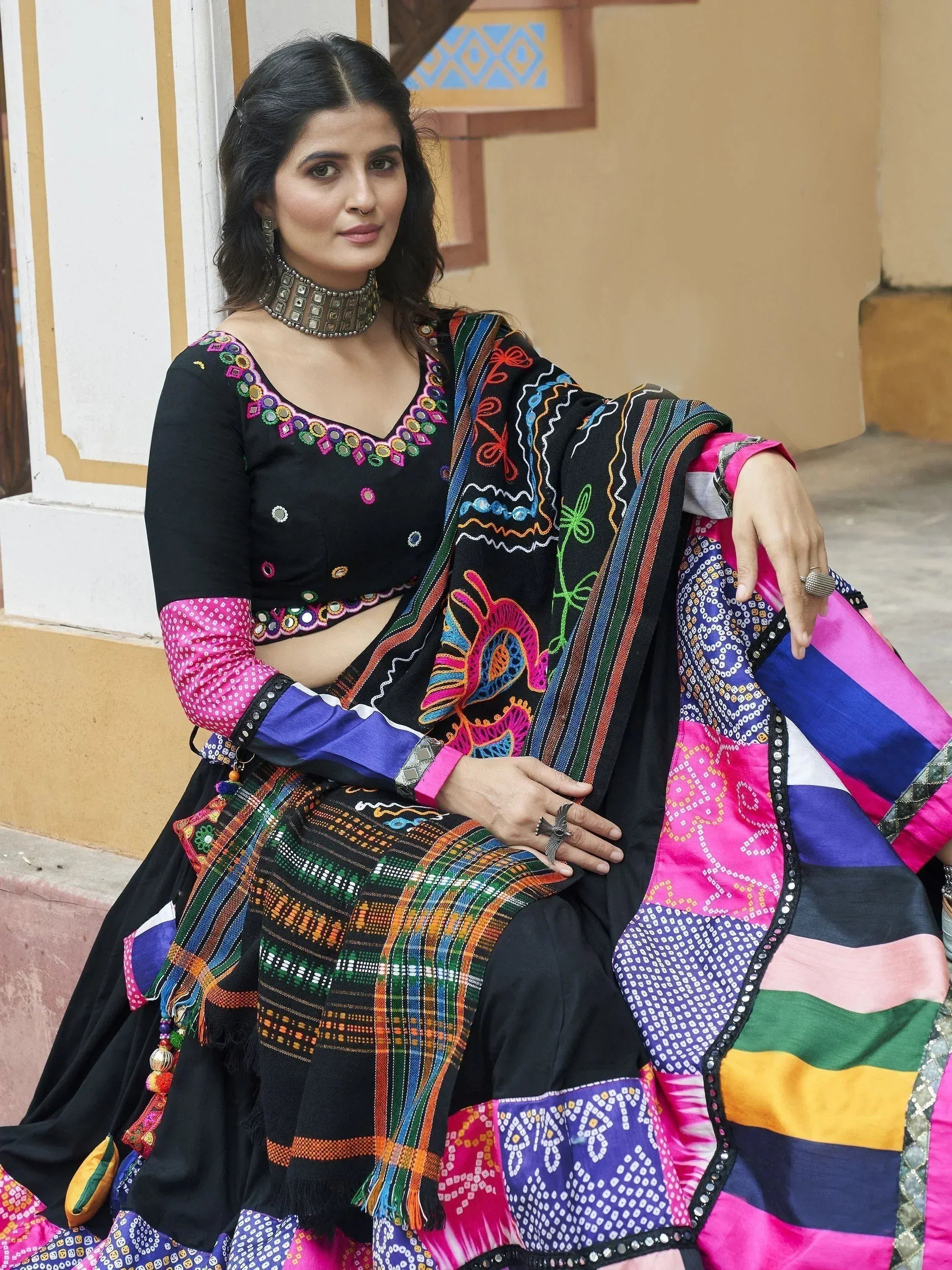 Black embroidered lehenga choli with colorful patchwork dupatta, perfect for Indian ethnic wear