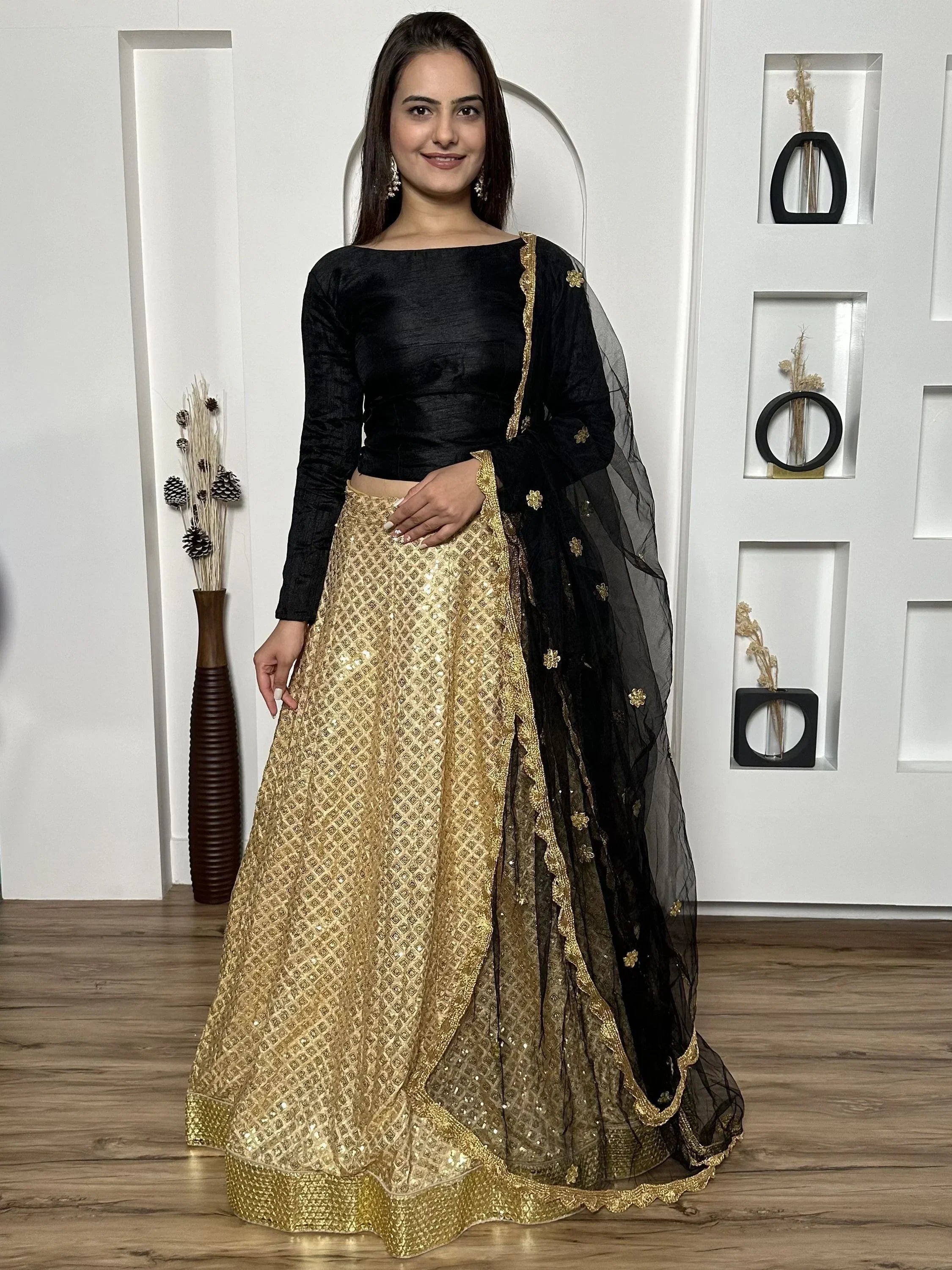 Black and gold designer lehenga choli with sequin work and sheer dupatta, perfect for Indian ethnic occasions