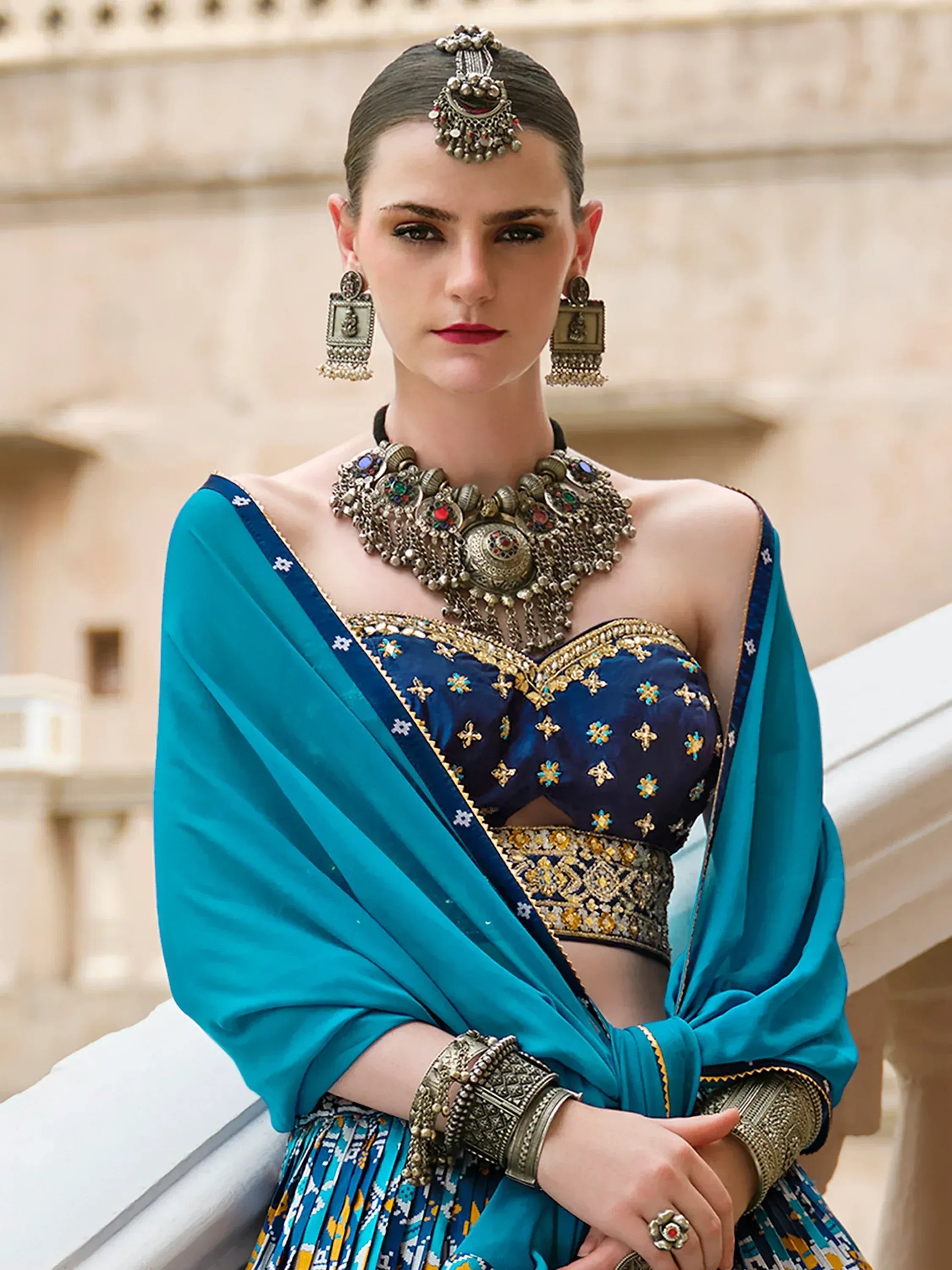 Blue embroidered lehenga choli with dupatta, traditional Indian ethnic wear, heavy jewelry