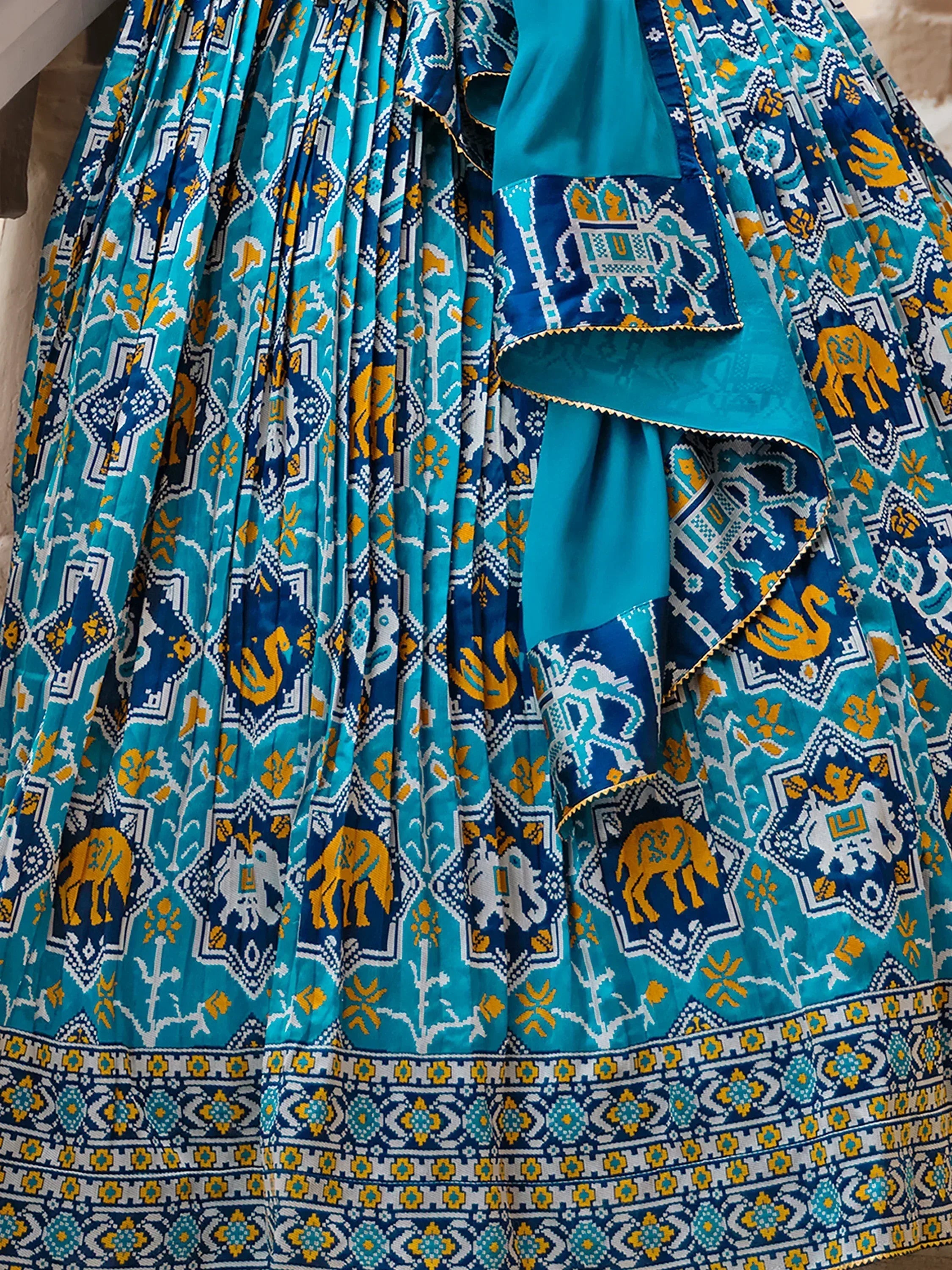 Turquoise and blue printed lehenga choli with elephant motifs, perfect for Indian ethnic wear