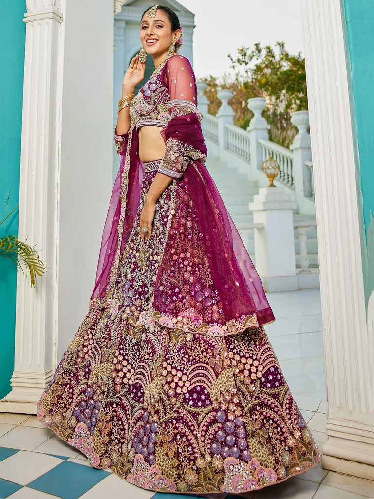 Elegant purple embroidered lehenga choli with floral motifs, perfect for Indian weddings and festive occasions.
