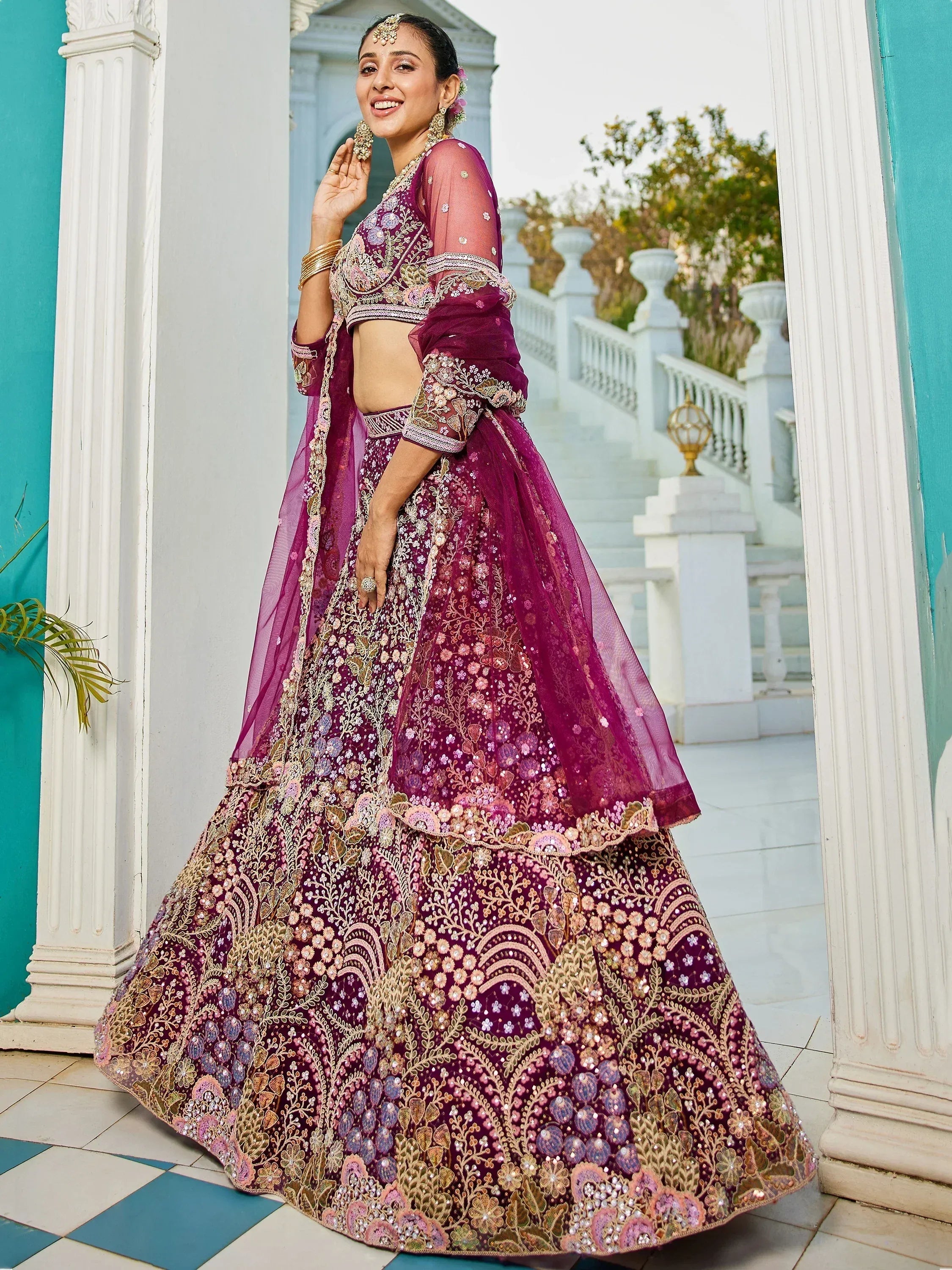 Elegant purple embroidered lehenga choli with floral motifs, perfect for Indian weddings and festive occasions.