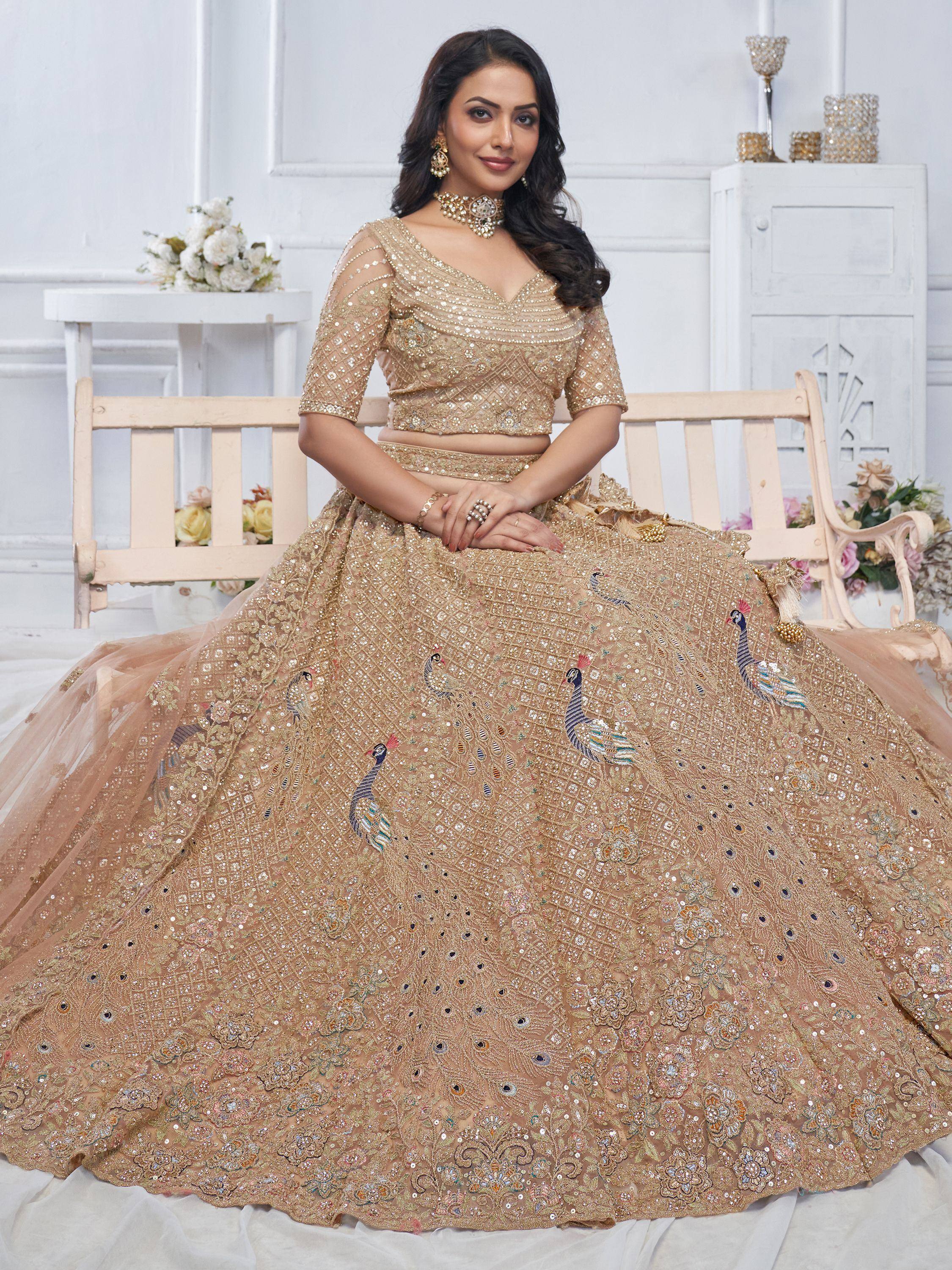 Elegant gold lehenga choli with peacock embroidery, perfect for Indian weddings and festive occasions.