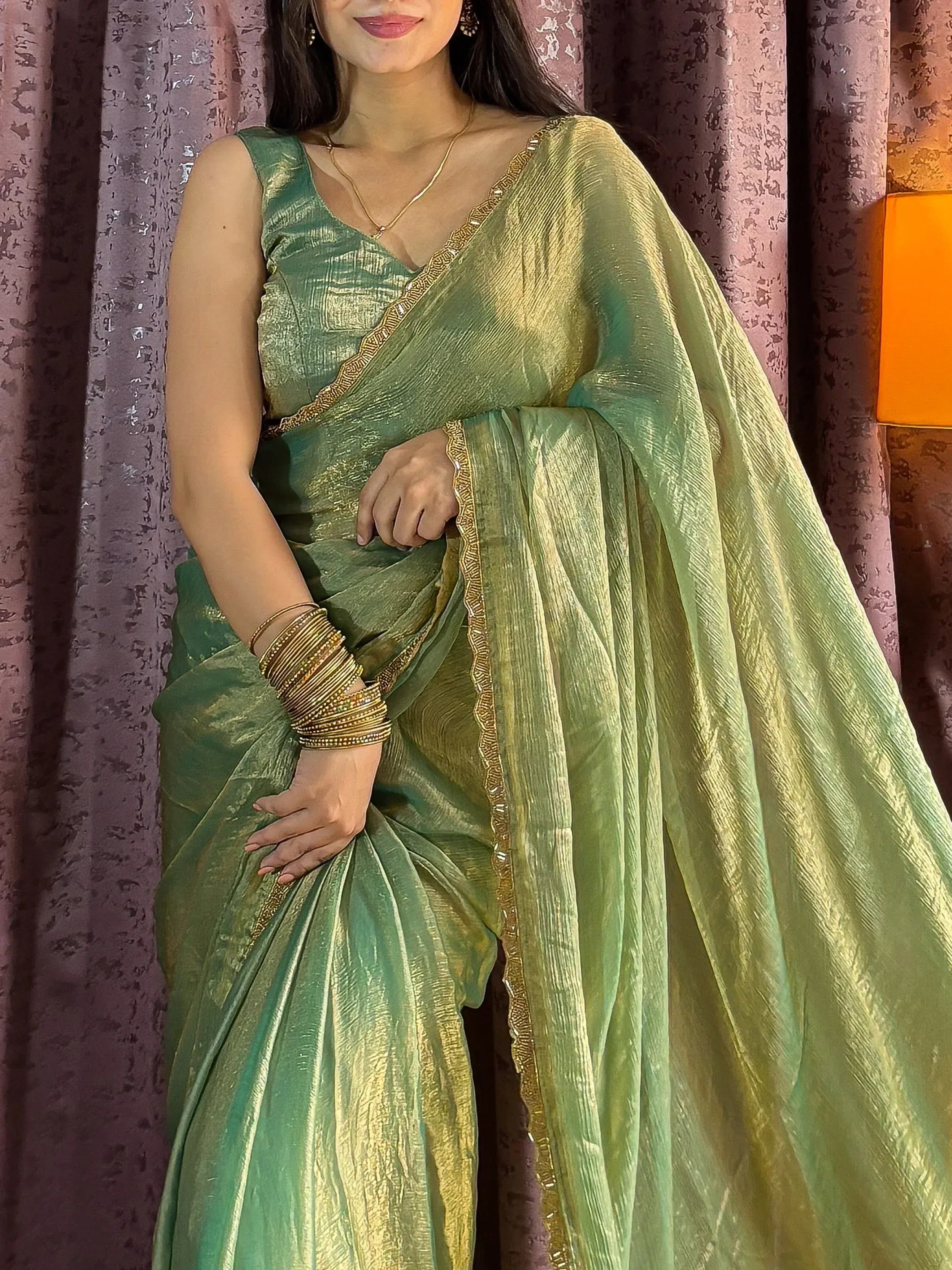 Elegant green and gold saree with intricate border, perfect for Indian ethnic occasions