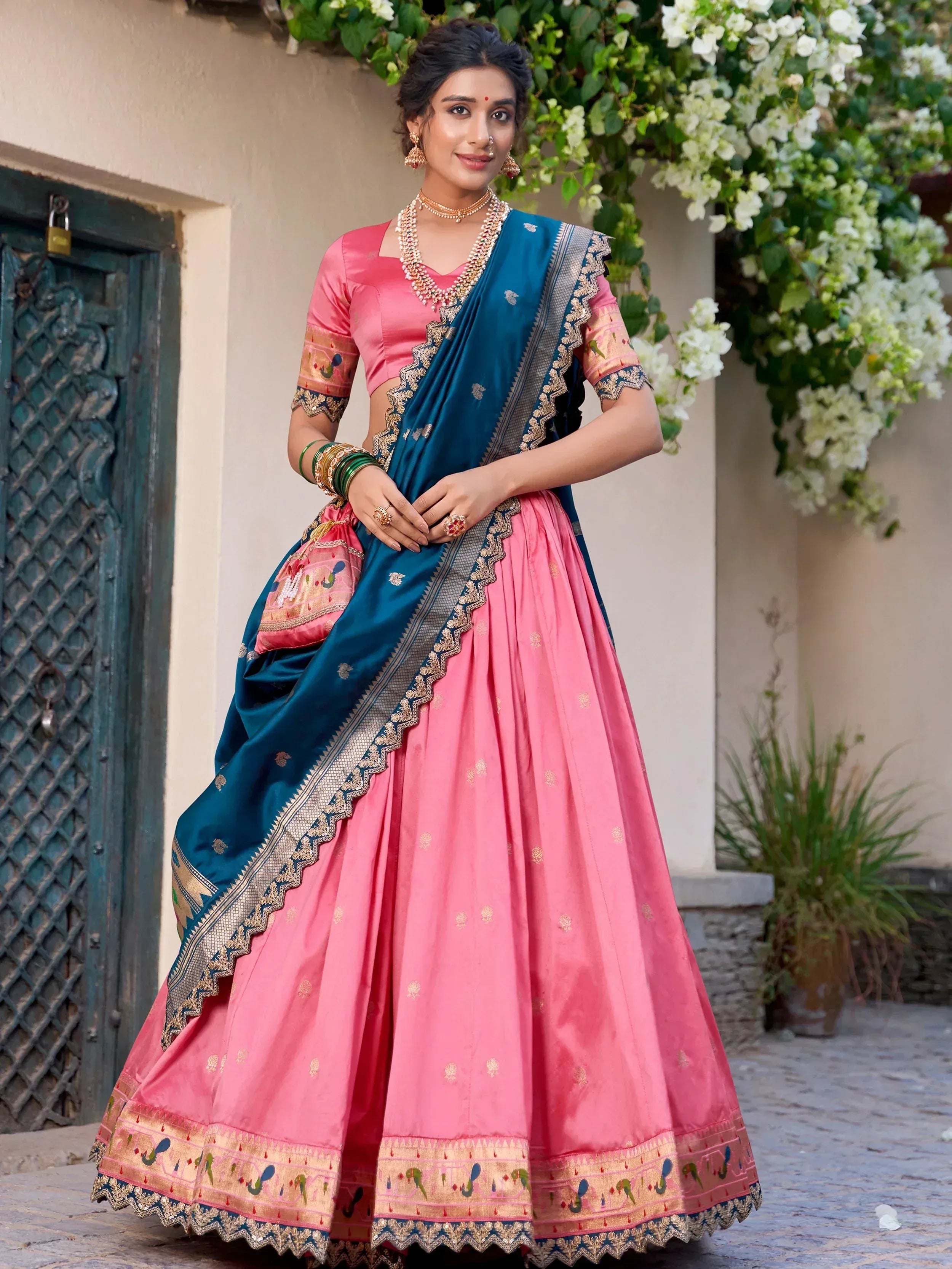 Pink and teal designer lehenga choli with gold embroidery, perfect for Indian ethnic wear occasions.