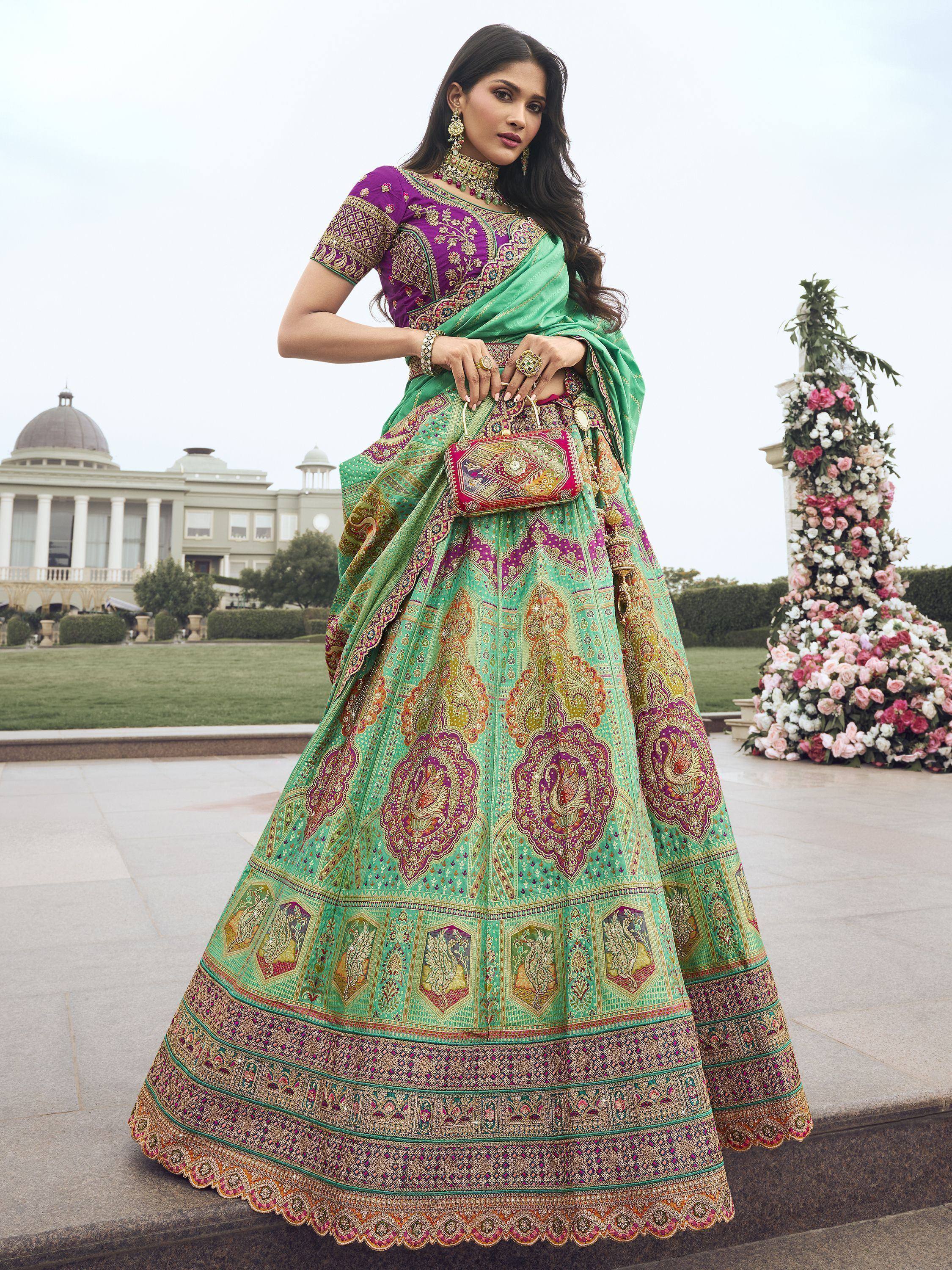 Elegant green and purple designer lehenga choli with intricate embroidery, perfect for Indian weddings and festive occasions.