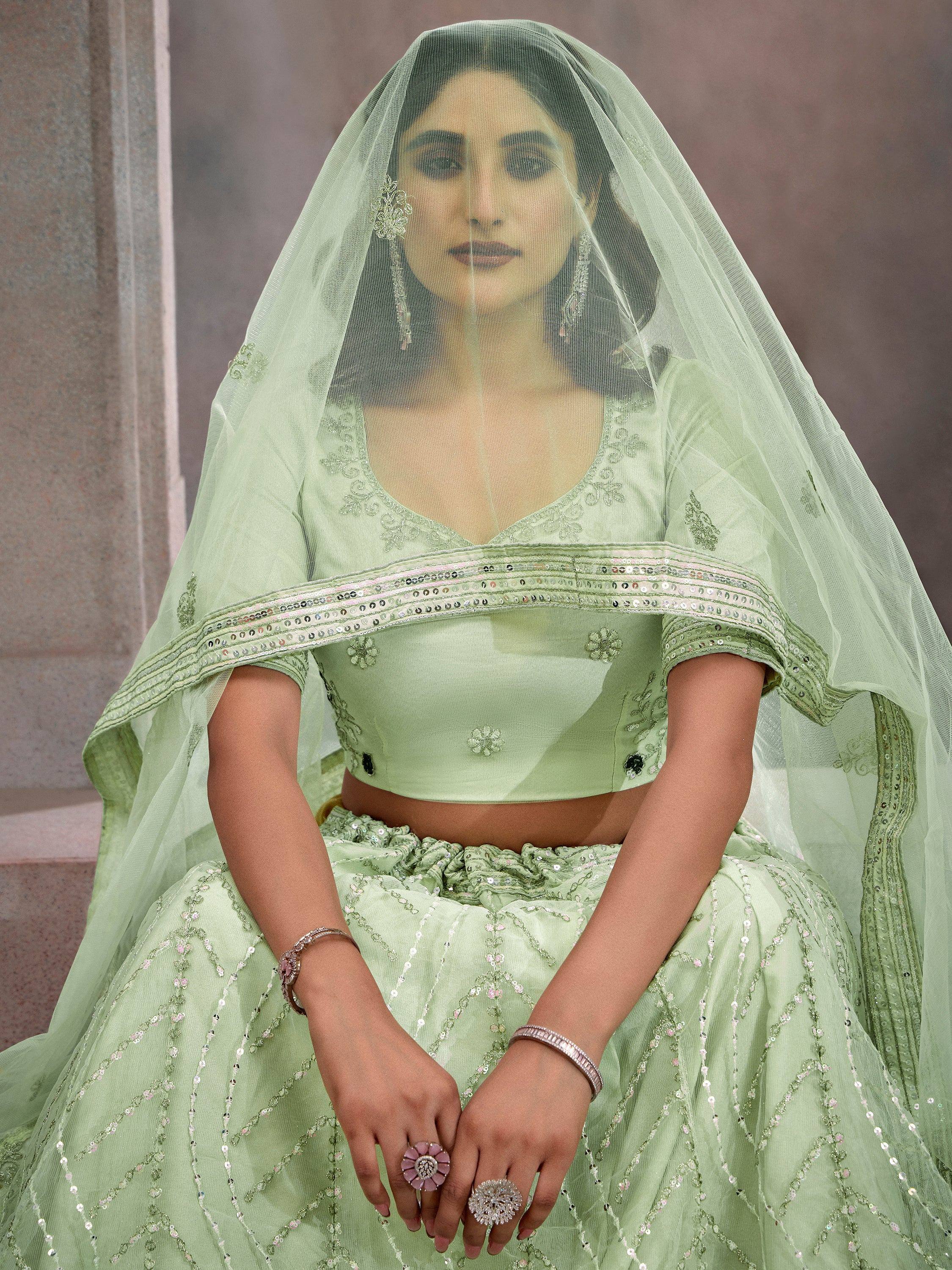 Mint green designer lehenga choli with sequin embroidery and sheer dupatta, perfect for Indian weddings.