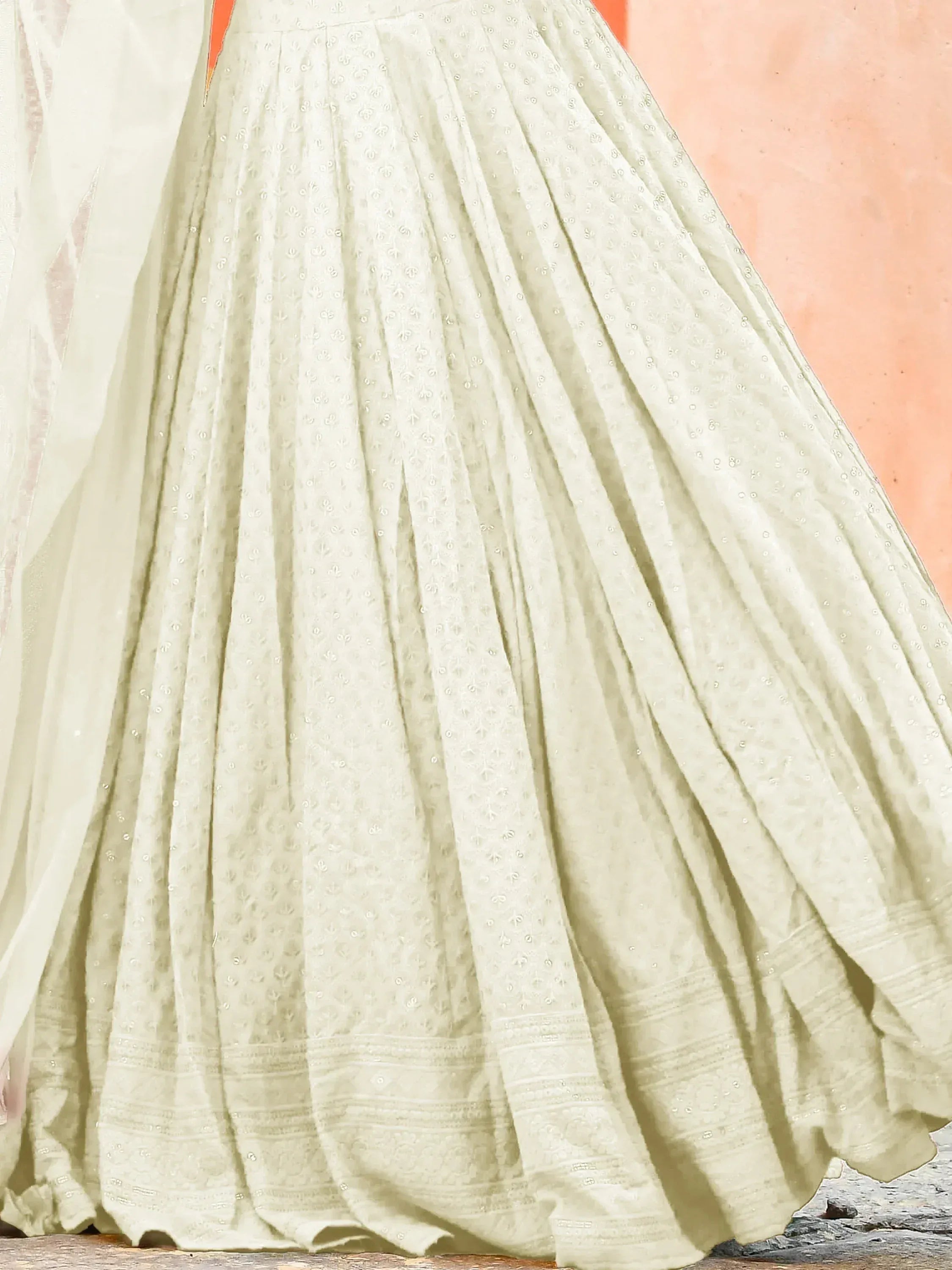 Ivory embroidered lehenga skirt with pleats and subtle floral motifs, ideal for ethnic wear occasions.