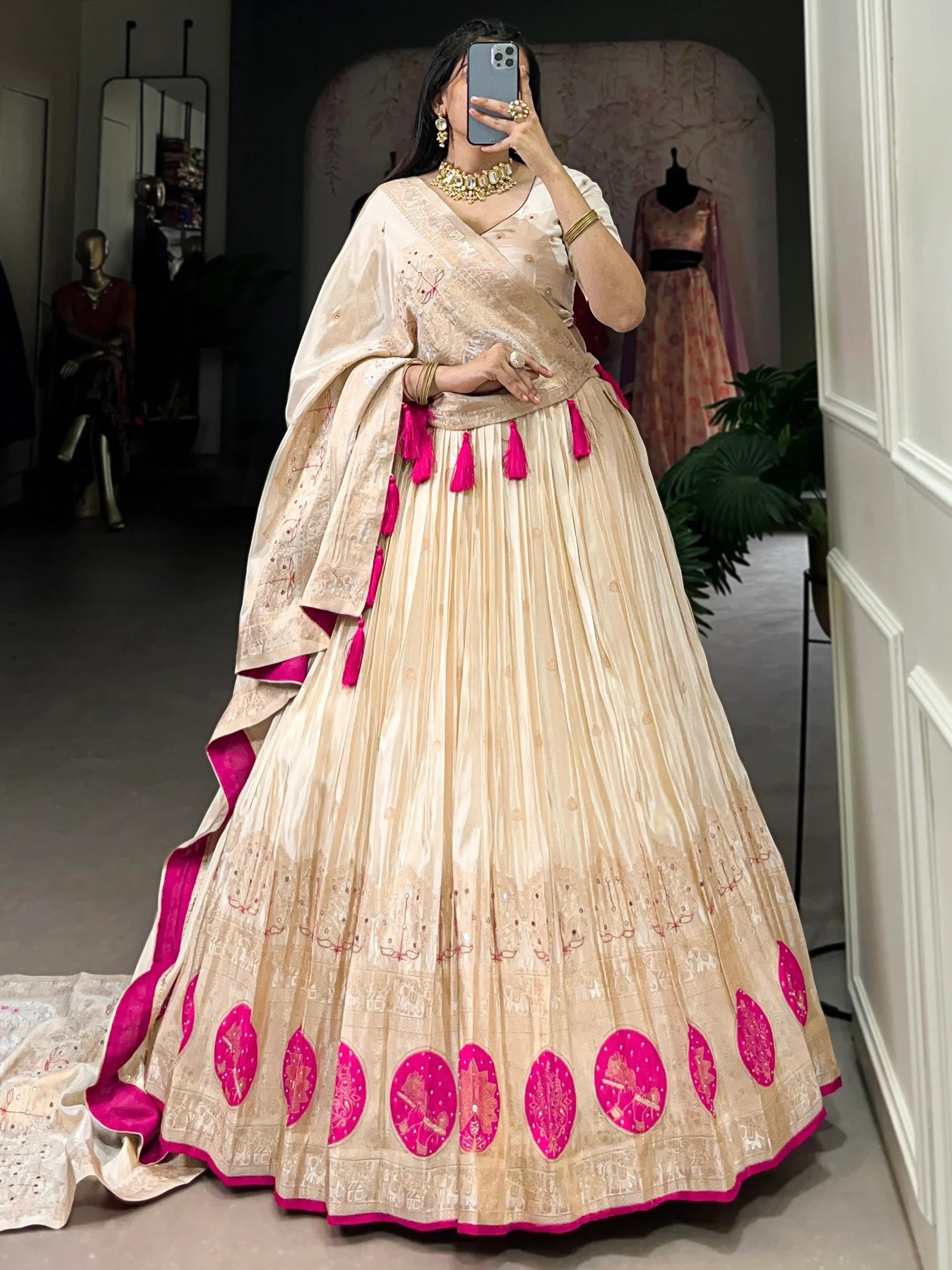 Cream and pink embroidered lehenga choli with tassels, perfect for Indian ethnic wear occasions