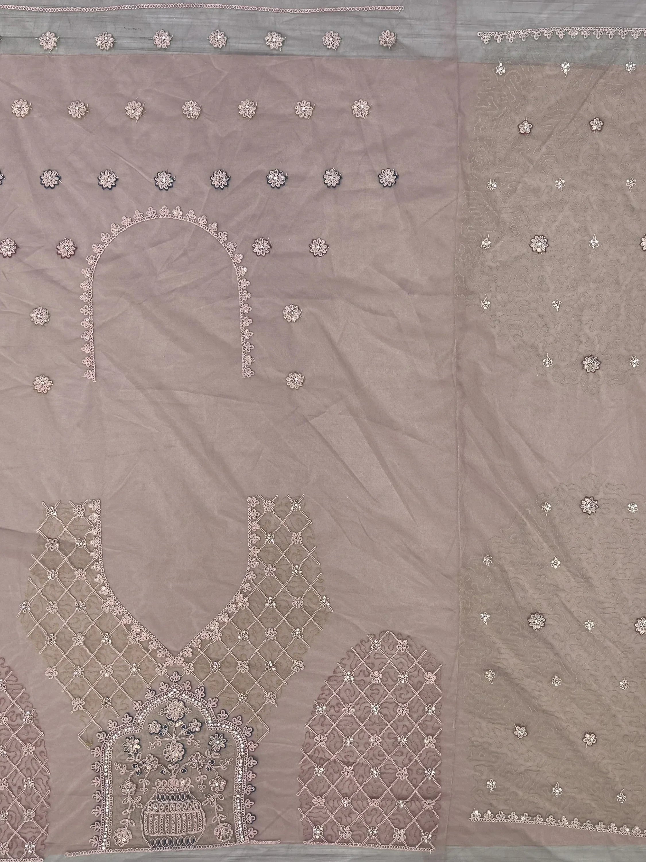 Elegant mauve salwar kameez with intricate floral embroidery and detailed neckline design