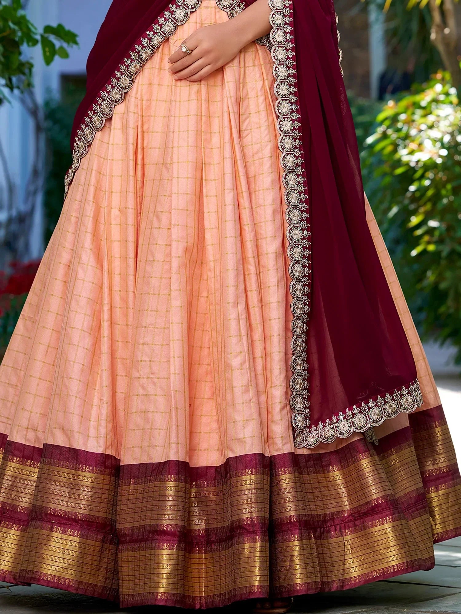 Peach and maroon ethnic lehenga with gold checks and embroidered border