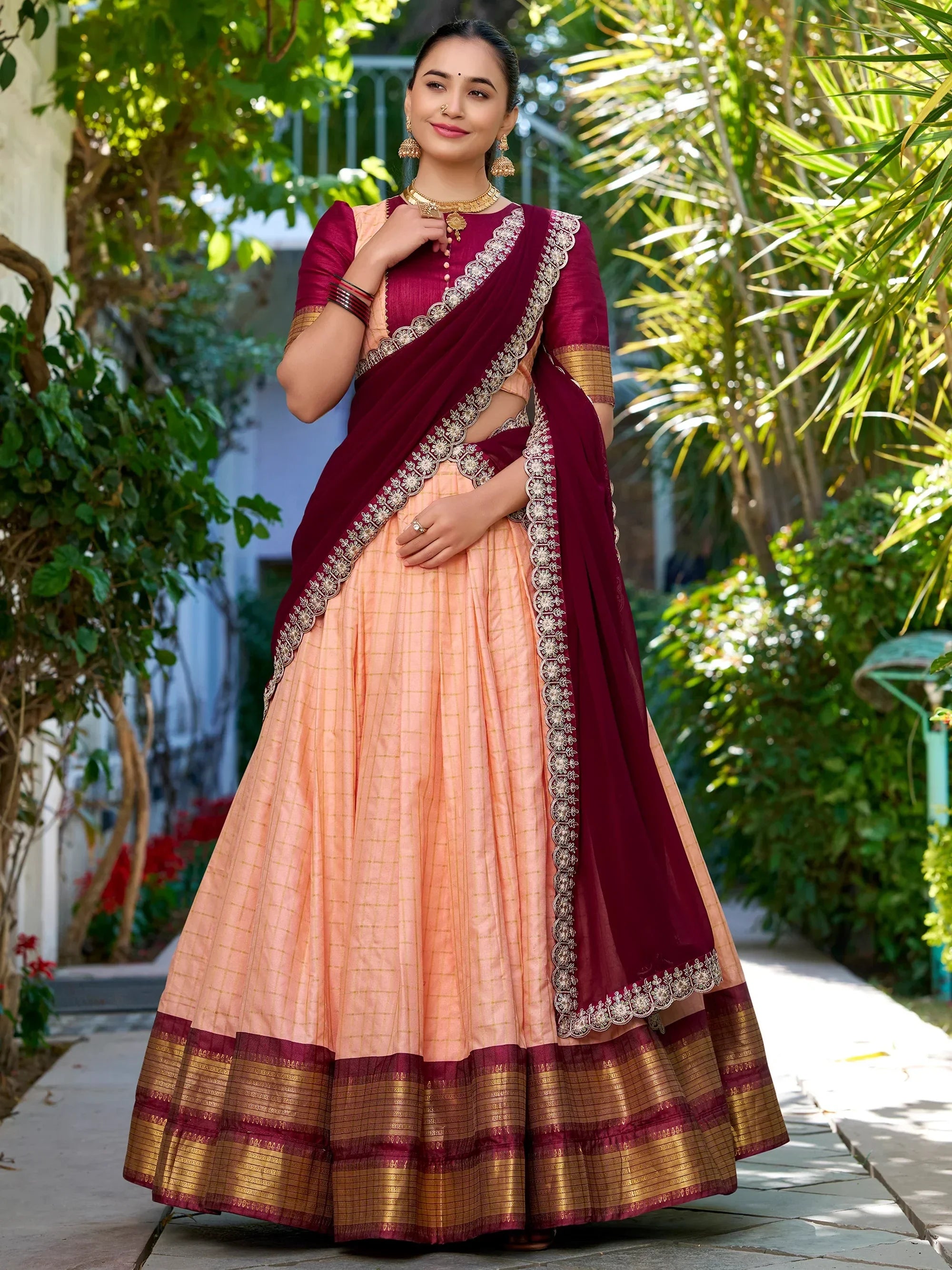 Elegant maroon and peach lehenga choli with gold embroidery, perfect for Indian ethnic wear.