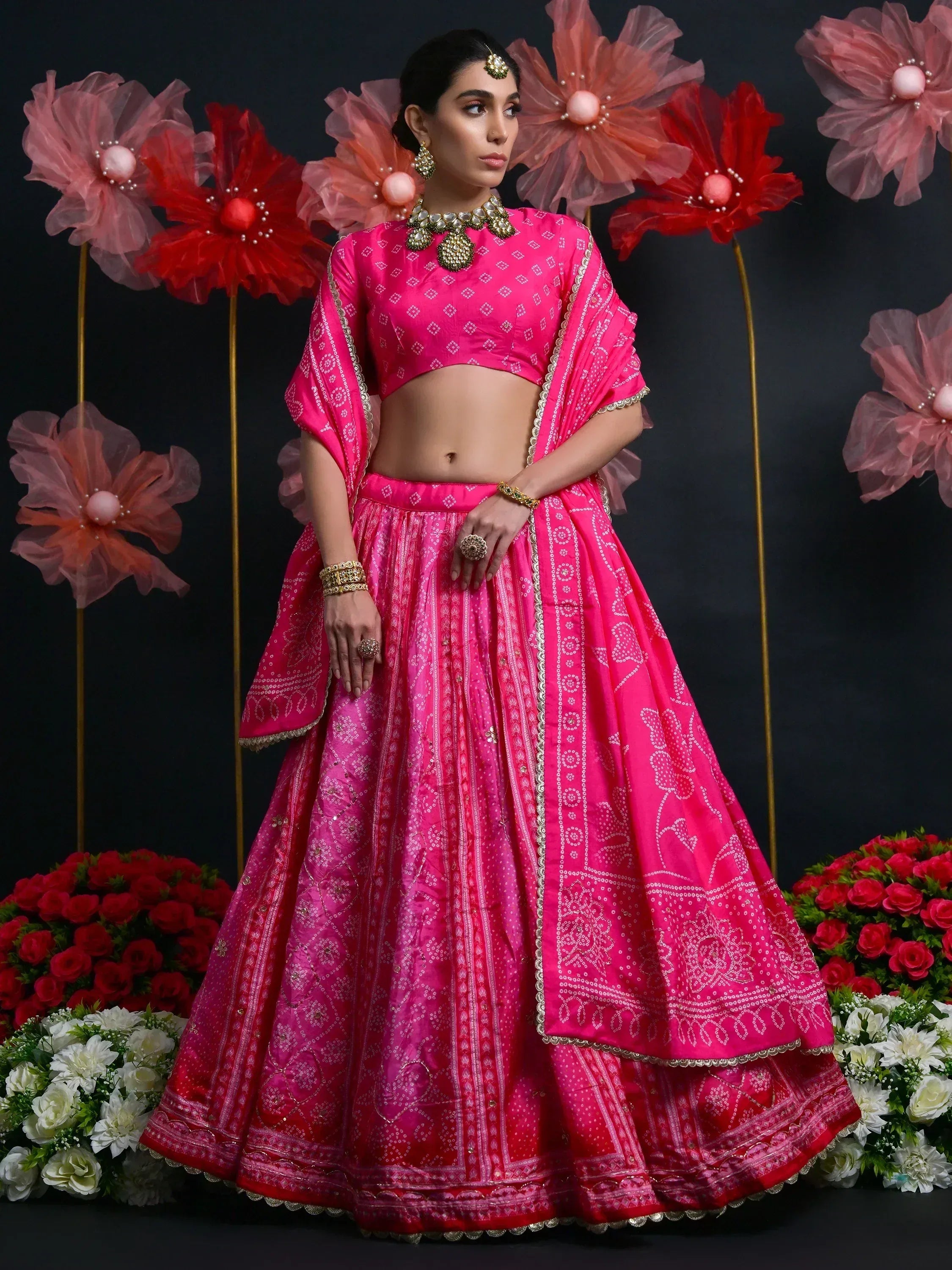 Pink designer lehenga choli with gold embroidery, perfect for Indian weddings and festive occasions.